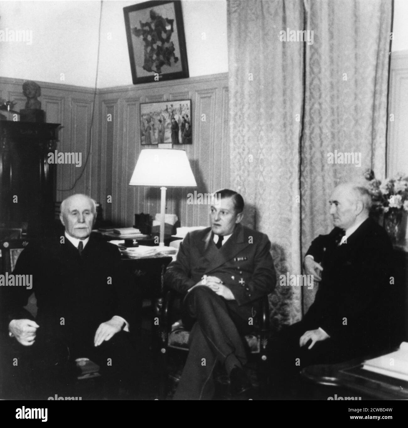Leaders of Vichy France, c1940-1942. Marshal Philippe Petain (left), Head of State of the Vichy regime established after the defeat of France in June 1940, with Admiral Francois Darlan (right), his deputy from February 1941 until November 1942. The two and the third, unidentified, man are meeting after having received the German ambassador, Otto Abetz. The photographer is unknown. Stock Photo