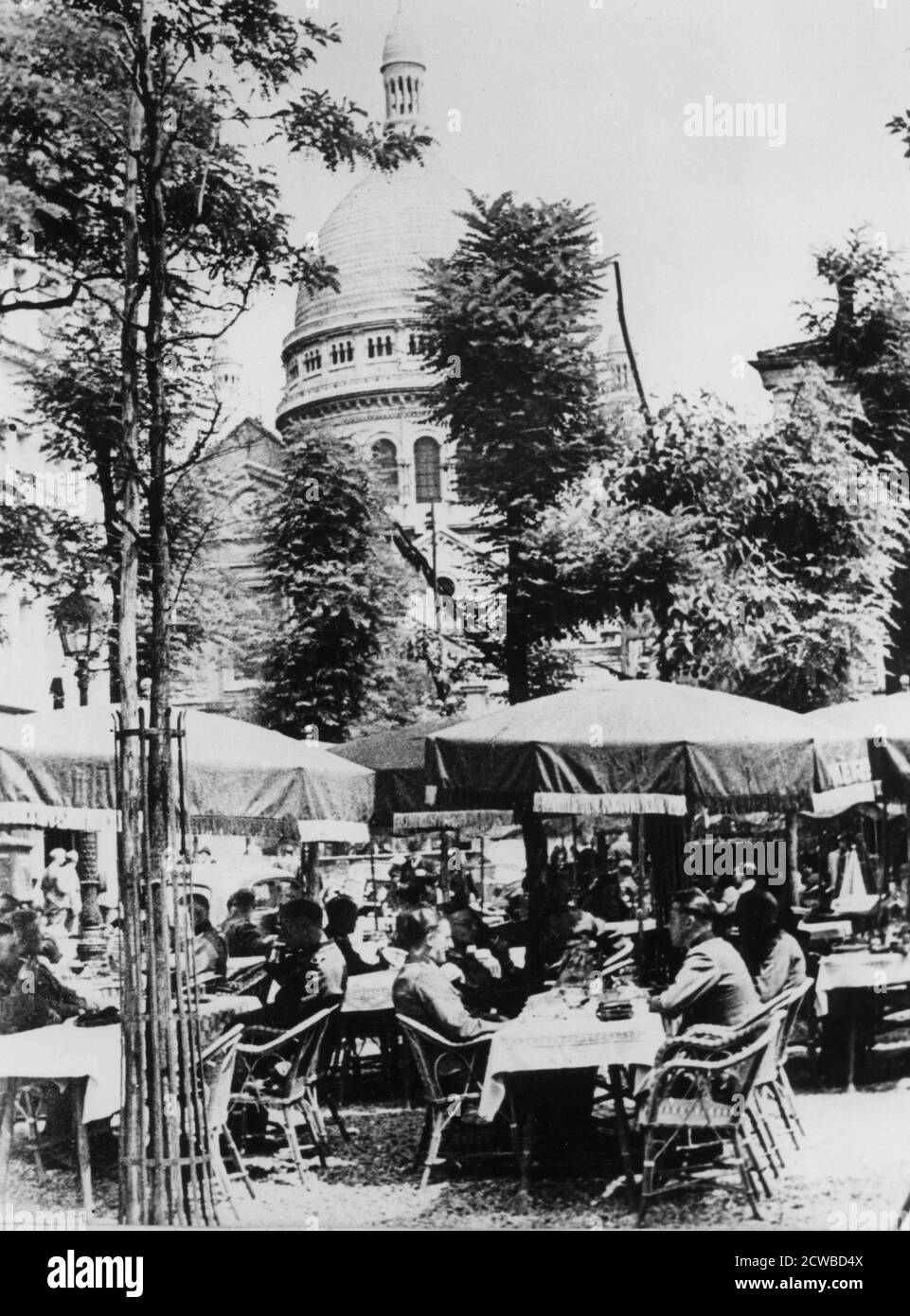 German soldiers relaxing outside a restaurant in Montmartre, Paris, June 1941. Occupied Paris was a desirable posting for members of the German military during World War II. The photographer is unknown. Stock Photo