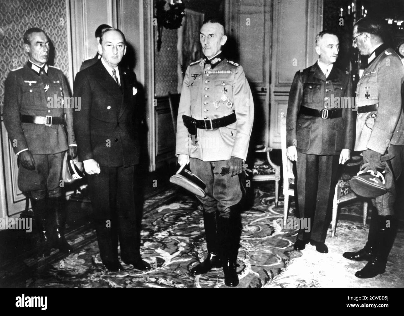Meeting between German officers and French Vichy government officials, France, 1940-1944. German officers, including Colonel Hans Speidel (right) meeting the Vichy French Minister of Defence, General Bridoux and the Vichy ambassador to the German High Command in Paris, Fernand de Brinon. The photographer is unknown. Stock Photo
