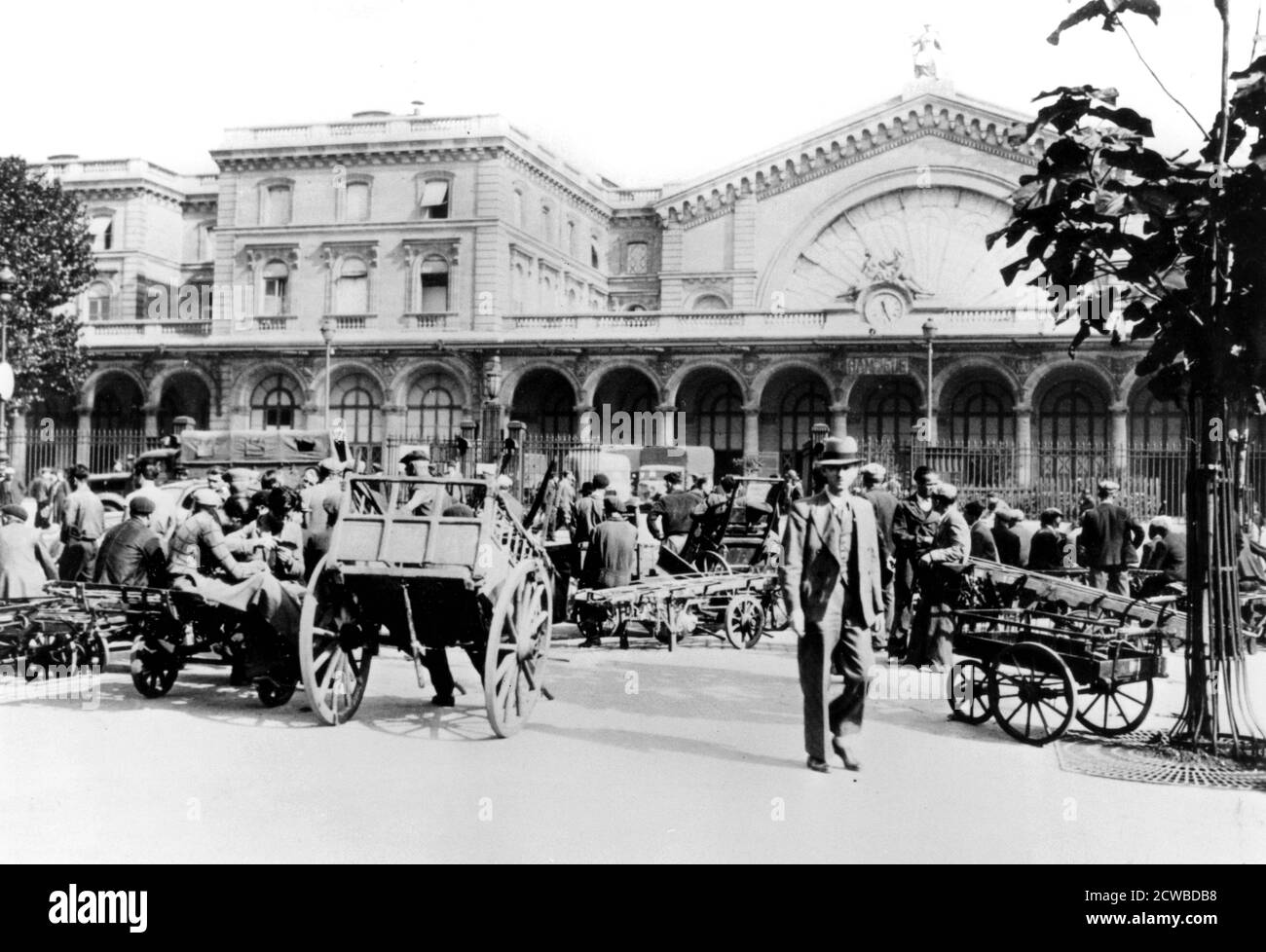 Outside the Gare de l'Est, in German-occupied Paris, September 1940. As the Germans restricted the use of petrol, handcarts replaced taxis as the means of transporting luggage. The photographer is unknown. Stock Photo