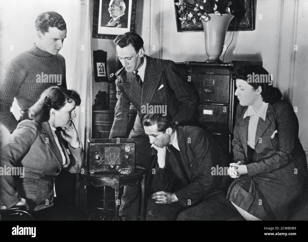 French citizens listening to a broadcast by Vichy deputy premier Admiral Francois Darlan, 23 May, 1941. The photographer is unknown. Stock Photo