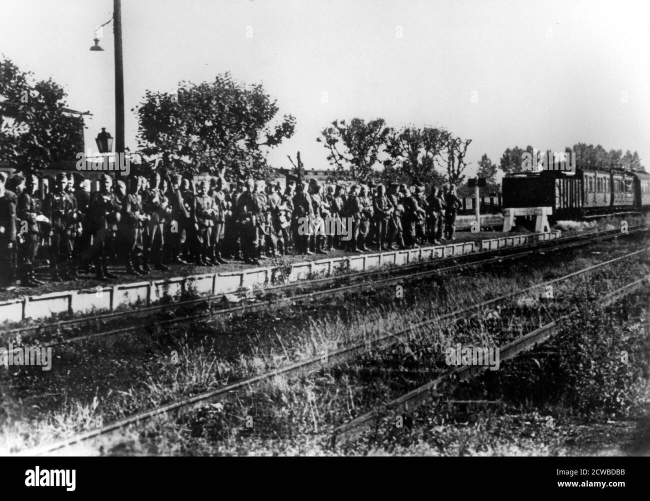 German soldiers on a railway platform awaiting transport, France, August 1940. The photographer is unknown. Stock Photo