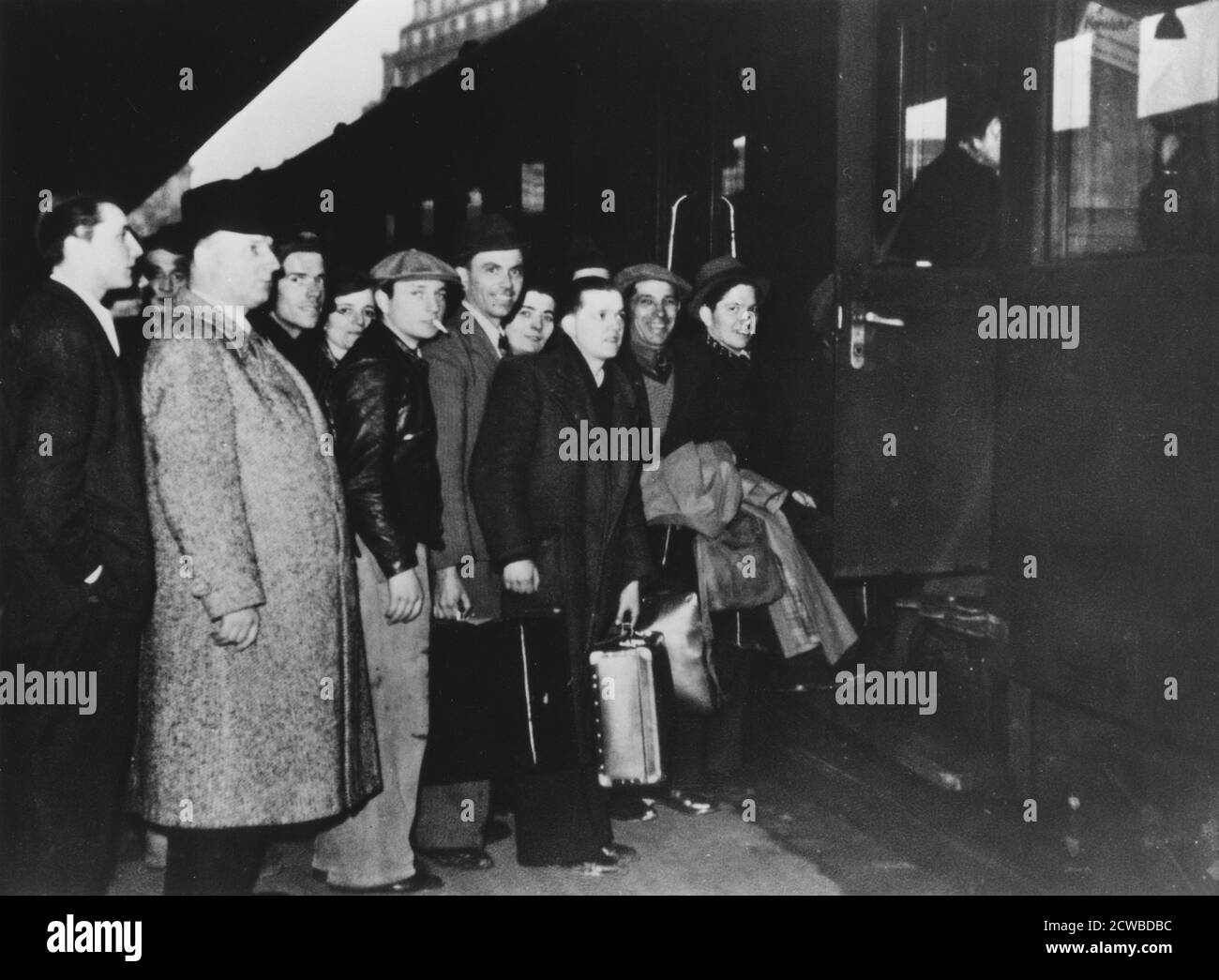 French conscript labour departing for Germany for service in the STO, Paris, 1943-1944. Faced with a decline in the supply of forced labour from occupied Poland and Russia, the Nazis demanded that France send 250,000 labourers to Germany by the end of 1942. As an incentive the Germans agreed to repatriate one French prisoner of war for every three volunteer labourers. But the volunteer numbers were insufficient and a form of conscription, the Service du Travail Obligatoire (STO) had to be introduced. By the time France was liberated an estimated 650,000 men and 44,000 women had been sent to wo Stock Photo