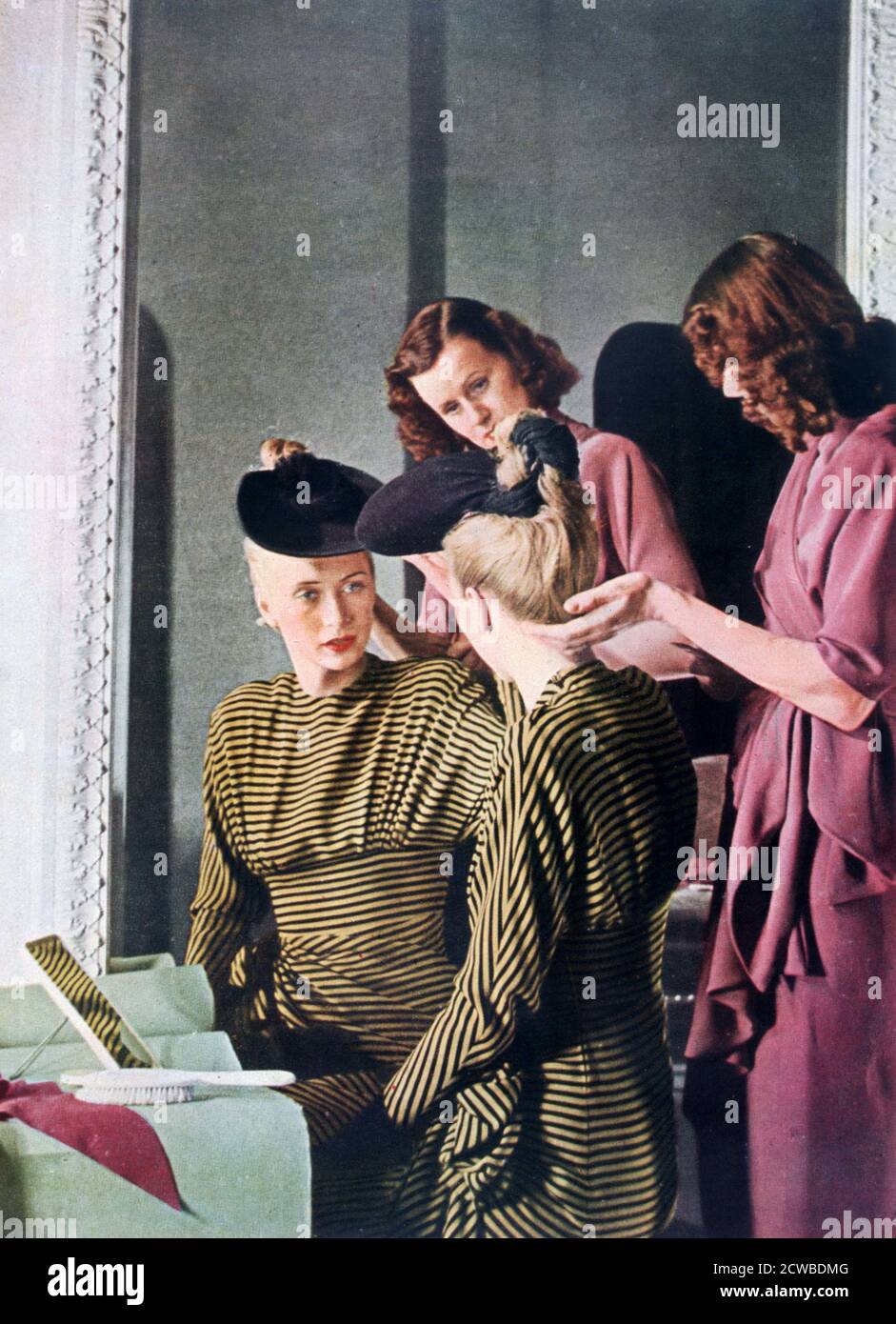 German women's fashion, 1942. A print from Signal, March 1942. Signal was a magazine published by the German Third Reich from 1940 through 1945. The artist is unknown. Stock Photo