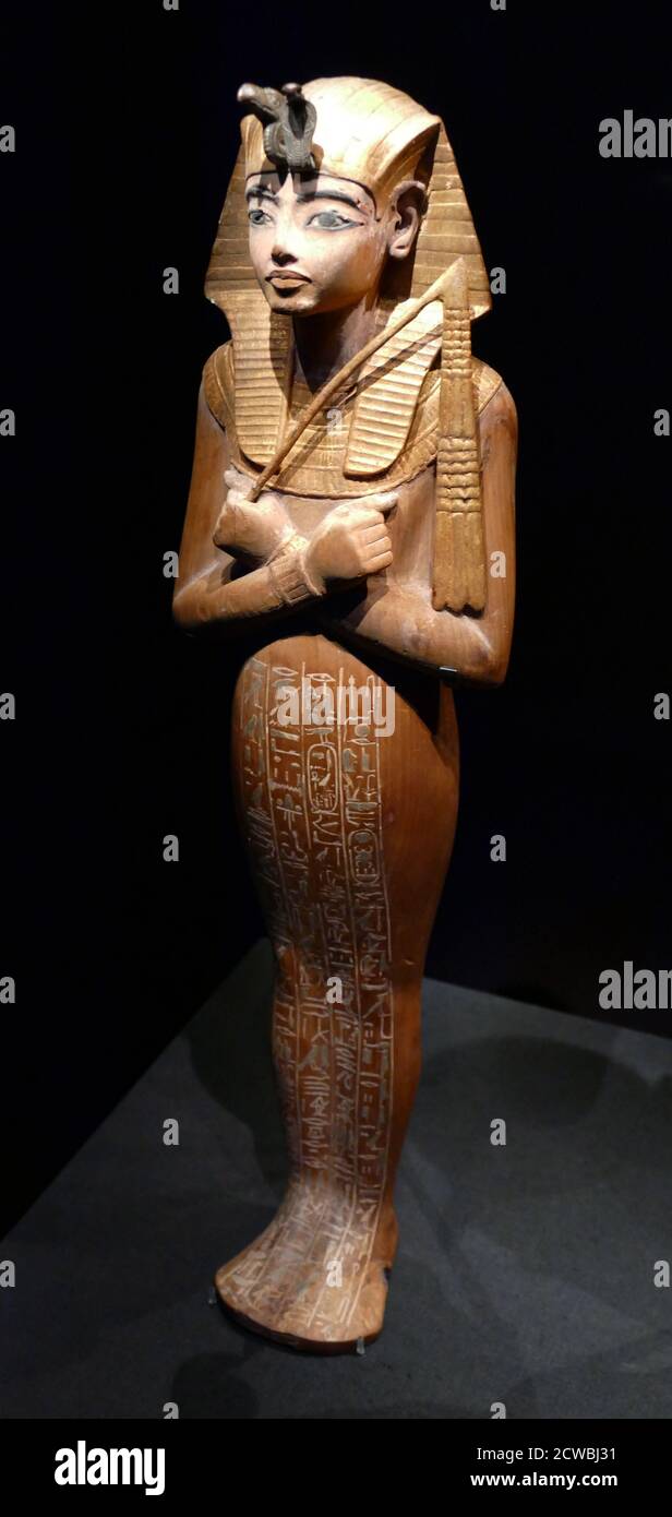 painted wooden Shabti figure, with gilded nemes headdress and collar. from the reign of Tutankhamun 1336-1326 BC. Stock Photo