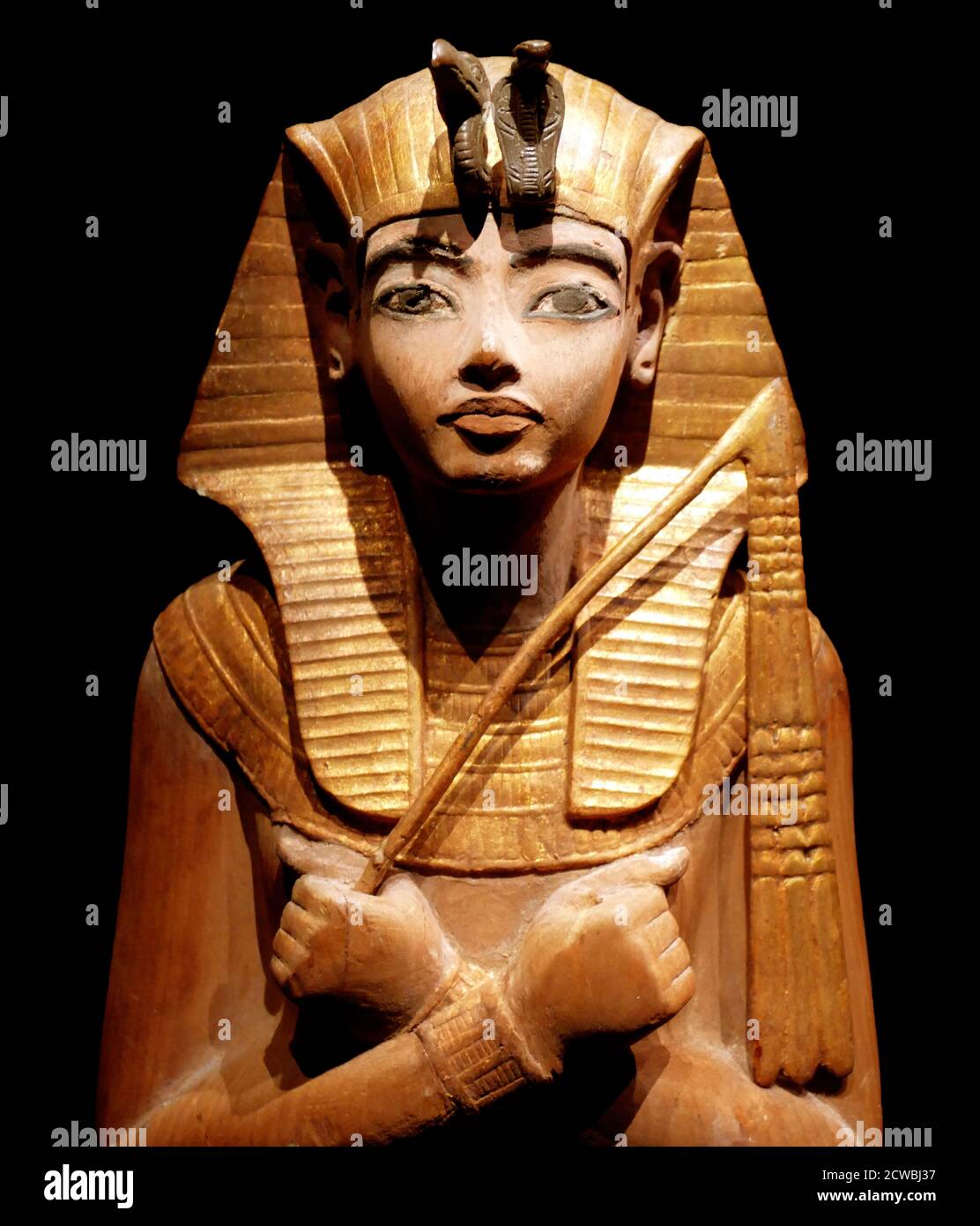 painted wooden Shabti figure, with gilded nemes headdress and collar. from the reign of Tutankhamun 1336-1326 BC. Stock Photo