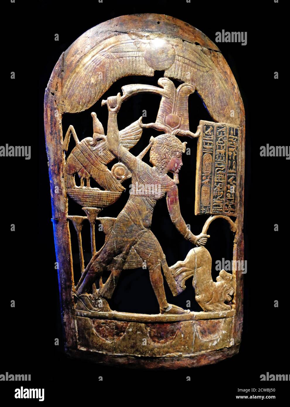 Gilded wooden ceremonial shield depicting King Tutankhamun wearing the Atef crown, hunting lions. from the tomb of the king. 1326 BC Stock Photo