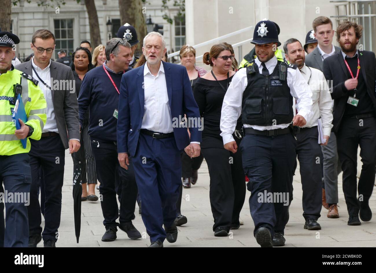 Photograph of Jeremy Corbyn being escorted by police to his office. Jeremy Bernard Corbyn (1949-) a British politician serving as Leader of the Labour Party and Leader of the Opposition since 2015 Stock Photo