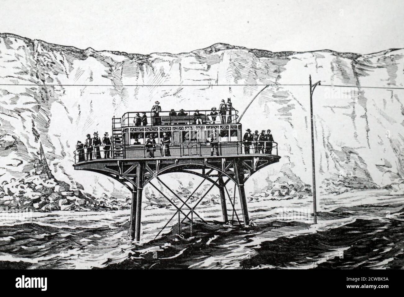 Engraving depicting Magnus Volk's electric trolley car which ran on rails laid down on the beach between Brighton and Rottingdean. This shows the car travelling in front of the cliffs with the tide in. Stock Photo