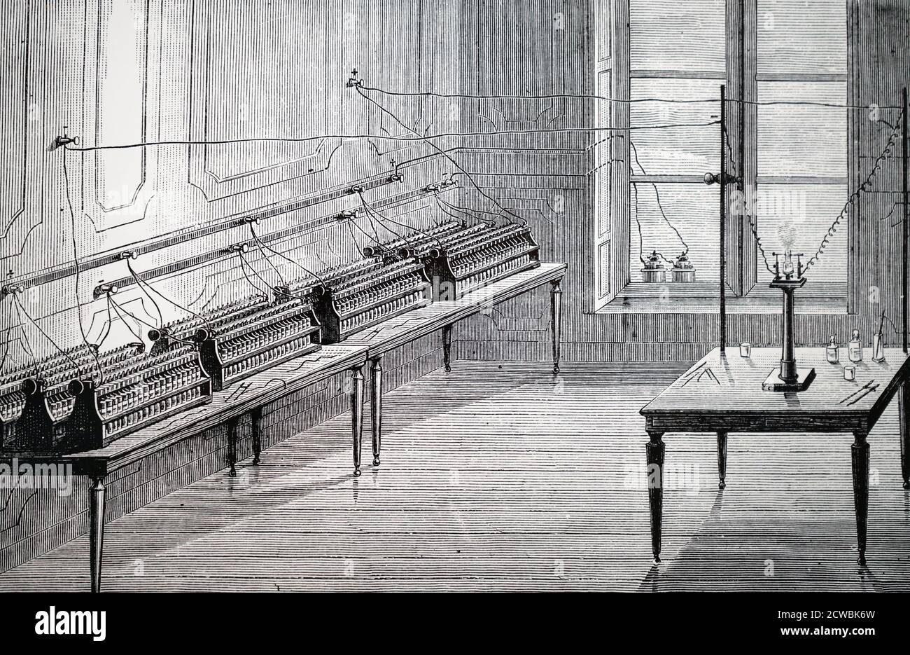 Engraving depicting a secondary battery. Battery of Plante cells (accumulators) of 200 elements. On the widow sill are the two Bunsen cells charging the Plante cells. Stock Photo