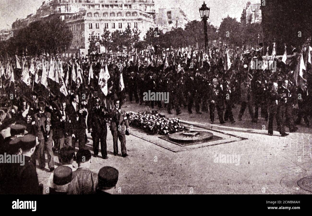 Black and white photo of a demonstration of the National Front in Paris, 14 July 1935; the flags of the 'Cross of Fire' as they march by the tomb of the unknown soldier. Stock Photo