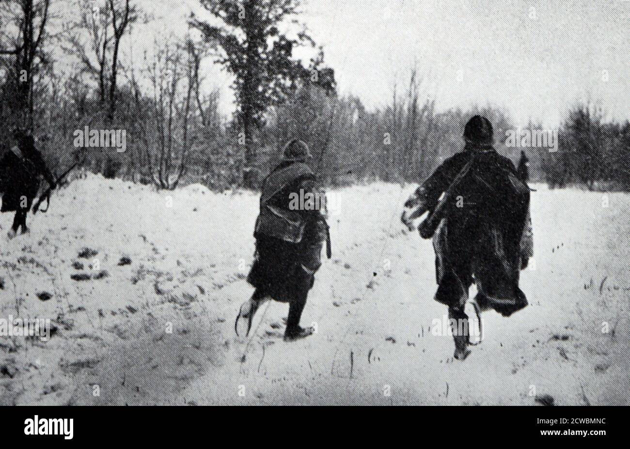 Black and white photograph of the front during the winter of 1939-1940; French troops patrol a wooded area. Stock Photo