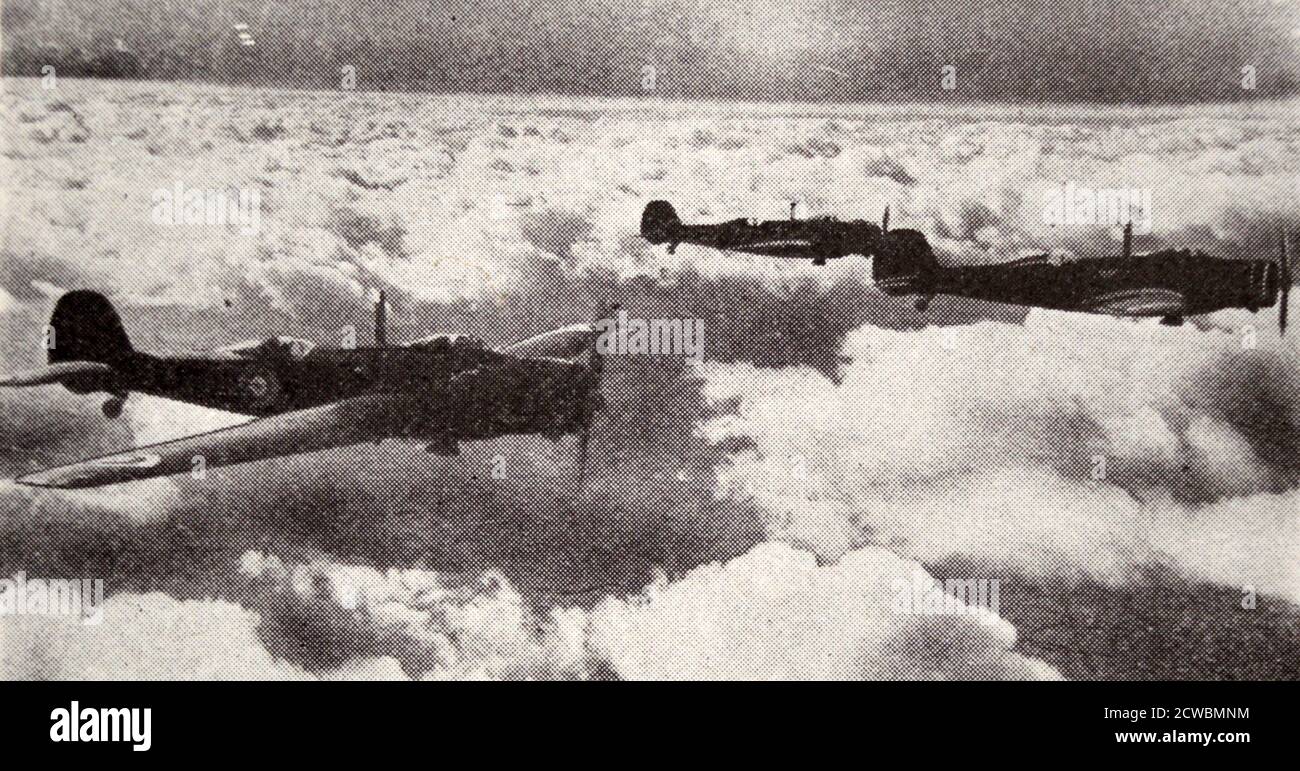 Black and white photograph of a squadron of fighter planes from the Royal Air Force flying over the sea. Stock Photo