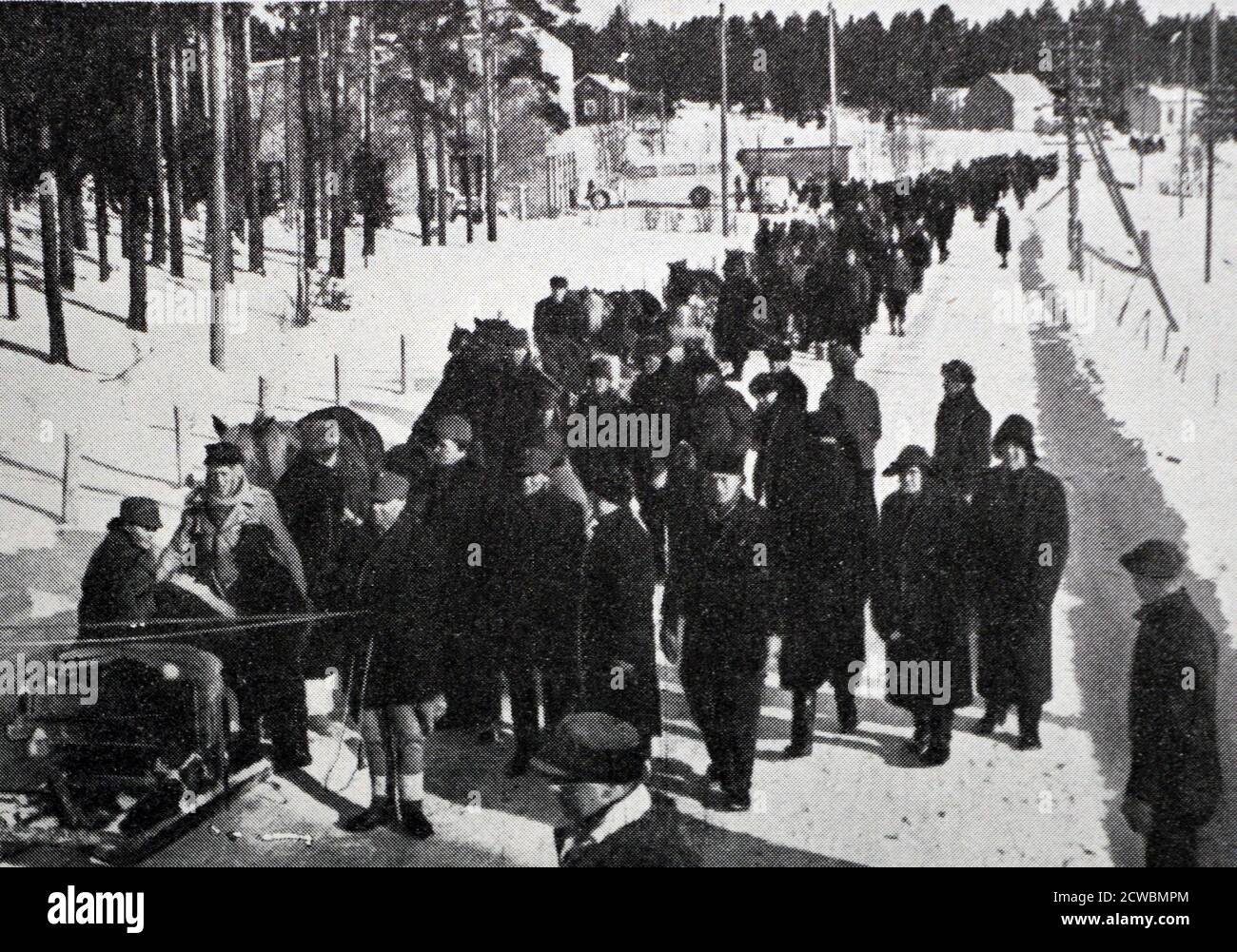 Black and white photograph of the Russian-Finnish War; Finnish civilians assisted by soldiers are evacuated from regions occupied by Soviet soldiers. Stock Photo