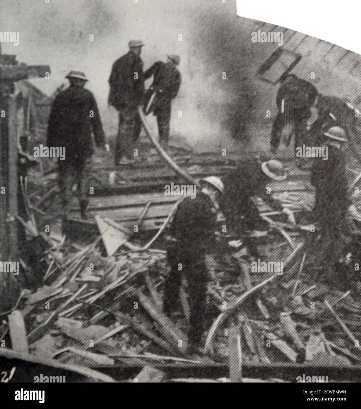 Black and White photograph of the bombing of London during the Battle of Britain in World War II (1939-1945); battling the fires. The fire brigade battle a fire in bombed out buildings in London. Stock Photo