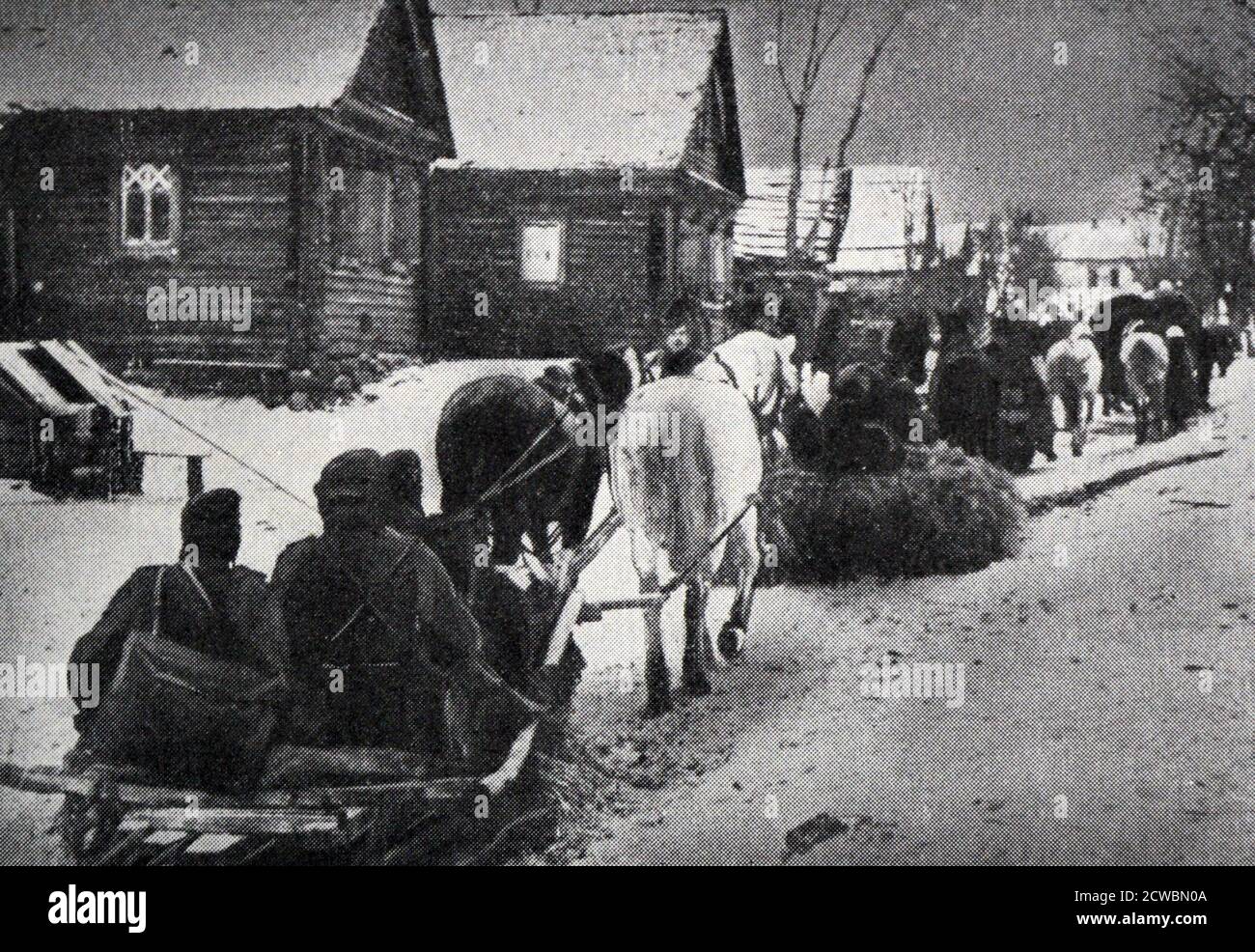Black and white photograph of World War II (1939-1945); on the Russian front in the lead up to winter 1942. German soldiers advance through the snow and a glacial cold spell on horse-drawn sleds. Stock Photo