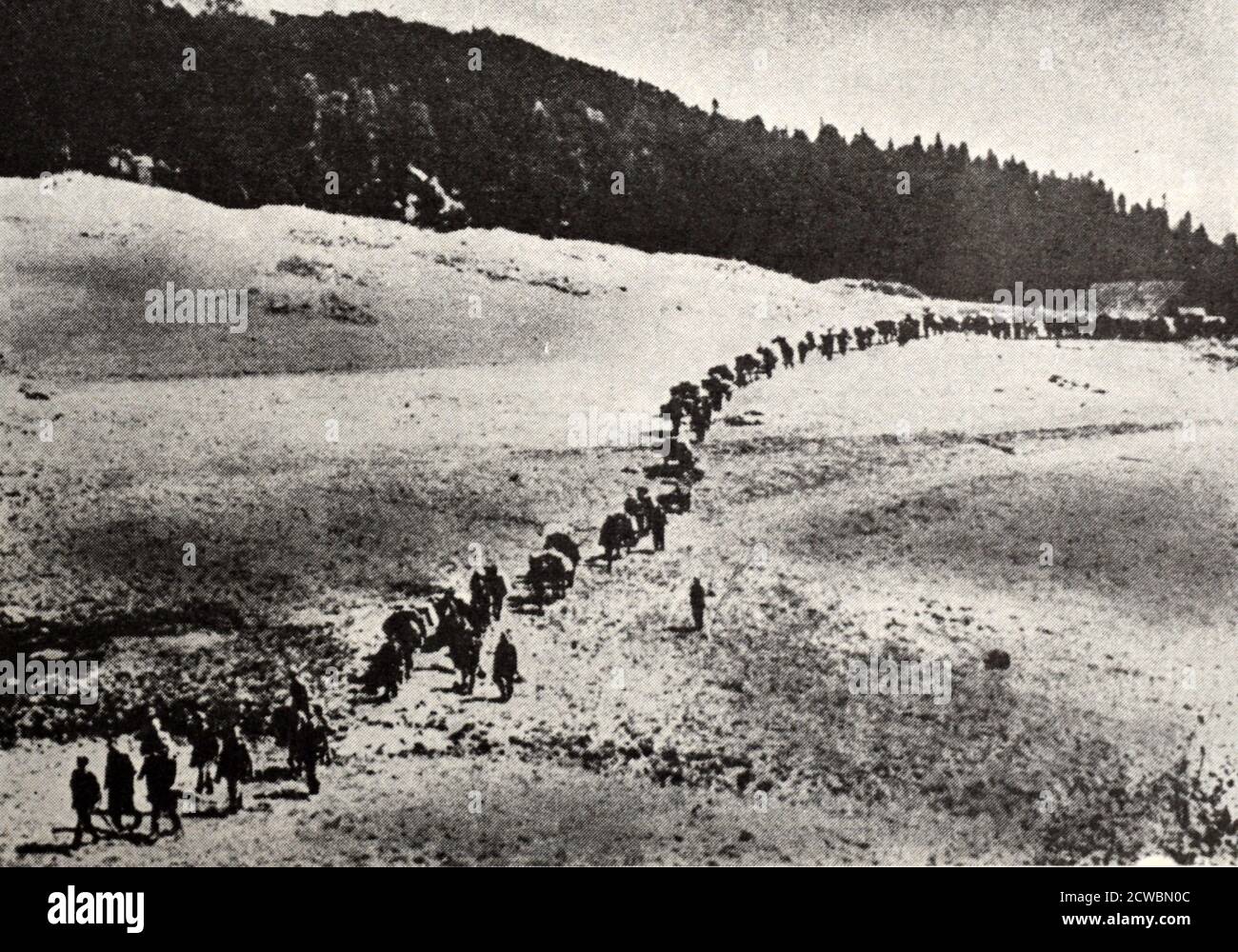Black and white photograph of World War II (1939-1945); a single-file column of German troops advance in the Caucasus Mountains. Stock Photo