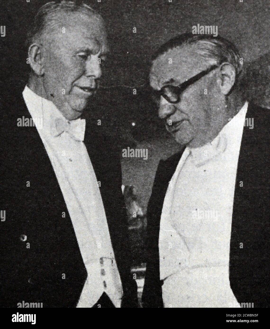 Black and white photograph of US General George Marshall (1880-1959), author of the Marshall Plan, speaking with British Foreign Minister Ernest Bevin (1881-1951). Both men are in formal dinner attire. Stock Photo