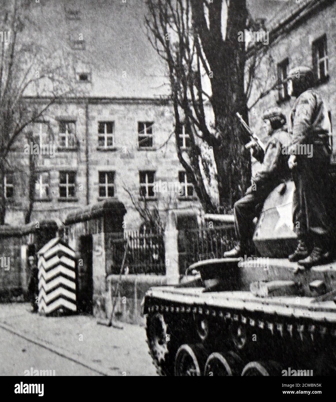 Black and white photograph of World War II (1939-1945) showing images related to the Nuremberg Trials, the largest prosecution in history, and which began in November 1945; the entrance of the prison in Nuremberg, guarded by Allied soldiers and a tank. Stock Photo