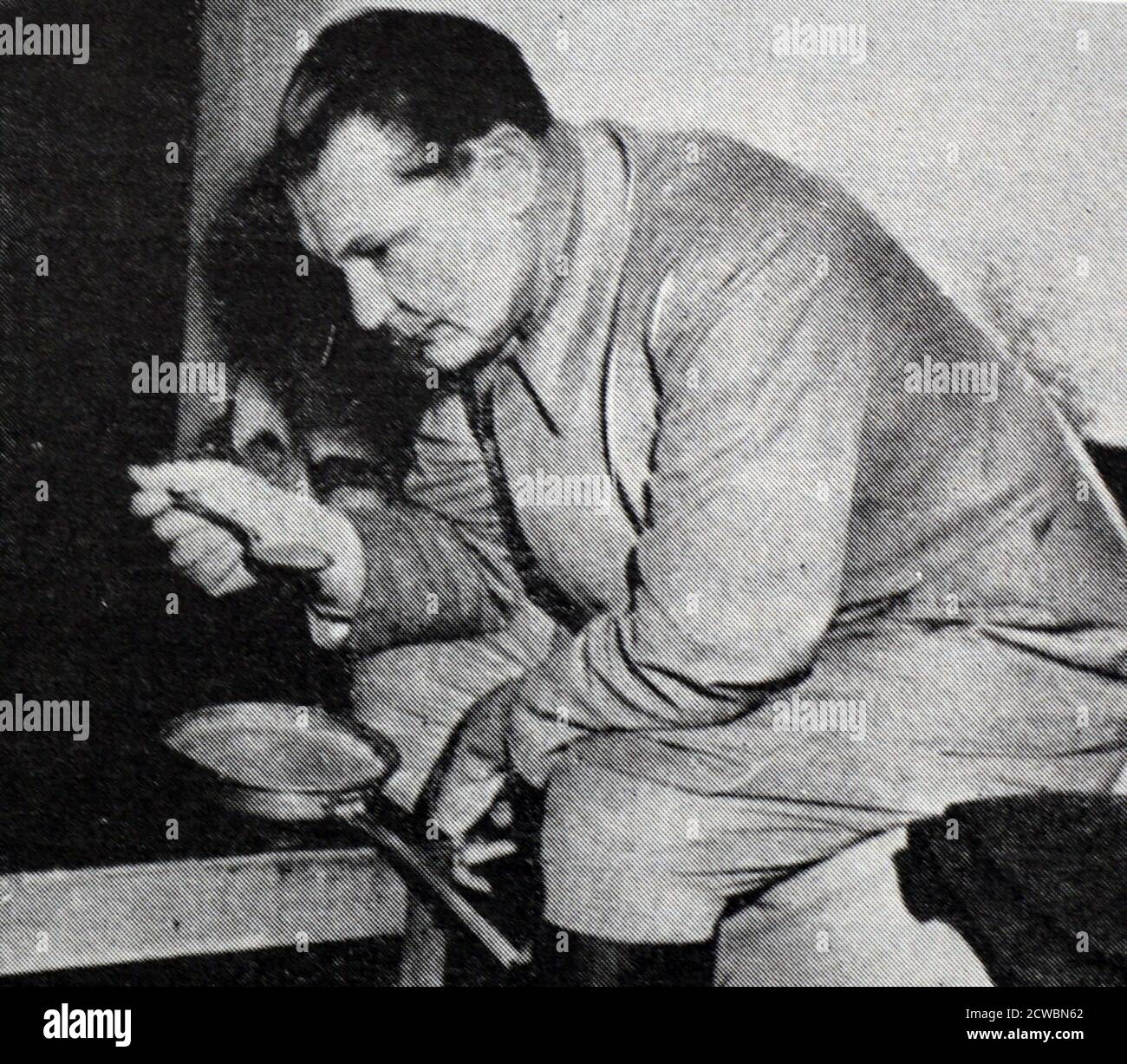Black and white photograph of World War II (1939-1945) showing images related to the Nuremberg Trials, the largest prosecution in history, and which began in November 1945; Goering having breakfast in his cell. Stock Photo