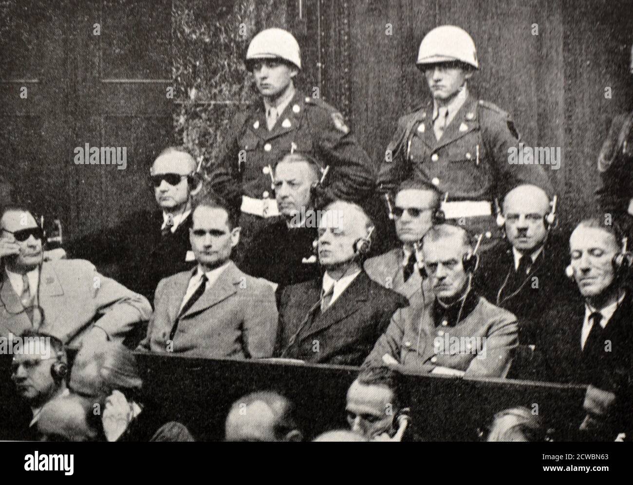Black and white photograph of World War II (1939-1945) showing images related to the Nuremberg Trials, the largest prosecution in history, and which began in November 1945; a group of the accused awaiting trial in the Court of Justice: Goering, Hess, Ribbentrop, Keitel, Rosenberg, Doenitz, Raeder, Baldur von Schirach and Sauckel. Stock Photo