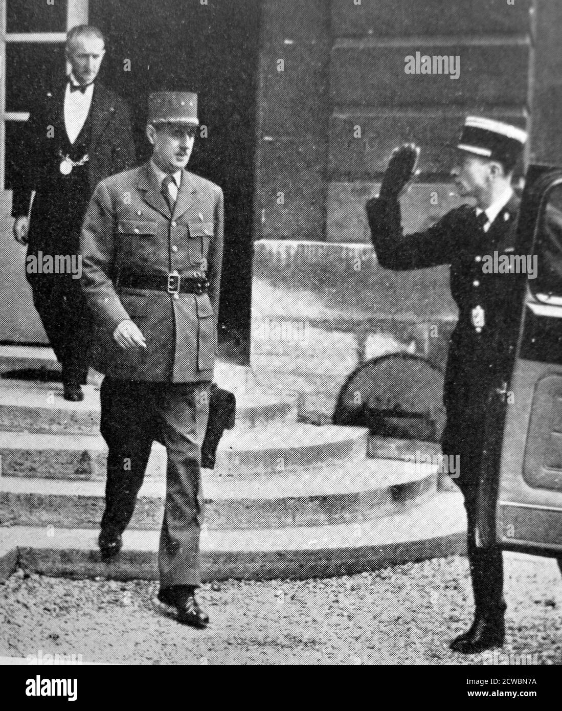 Black and white photograph of French General Charles de Gaulle (1890-1970), leaving a meeting of the Council of Ministers. Stock Photo