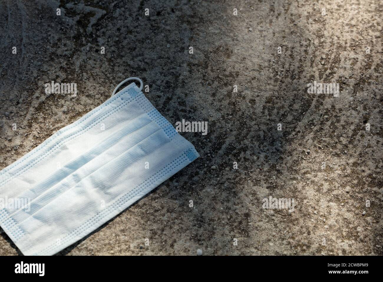 Medical protection mask lost on the ground was used. Disposable mask ...
