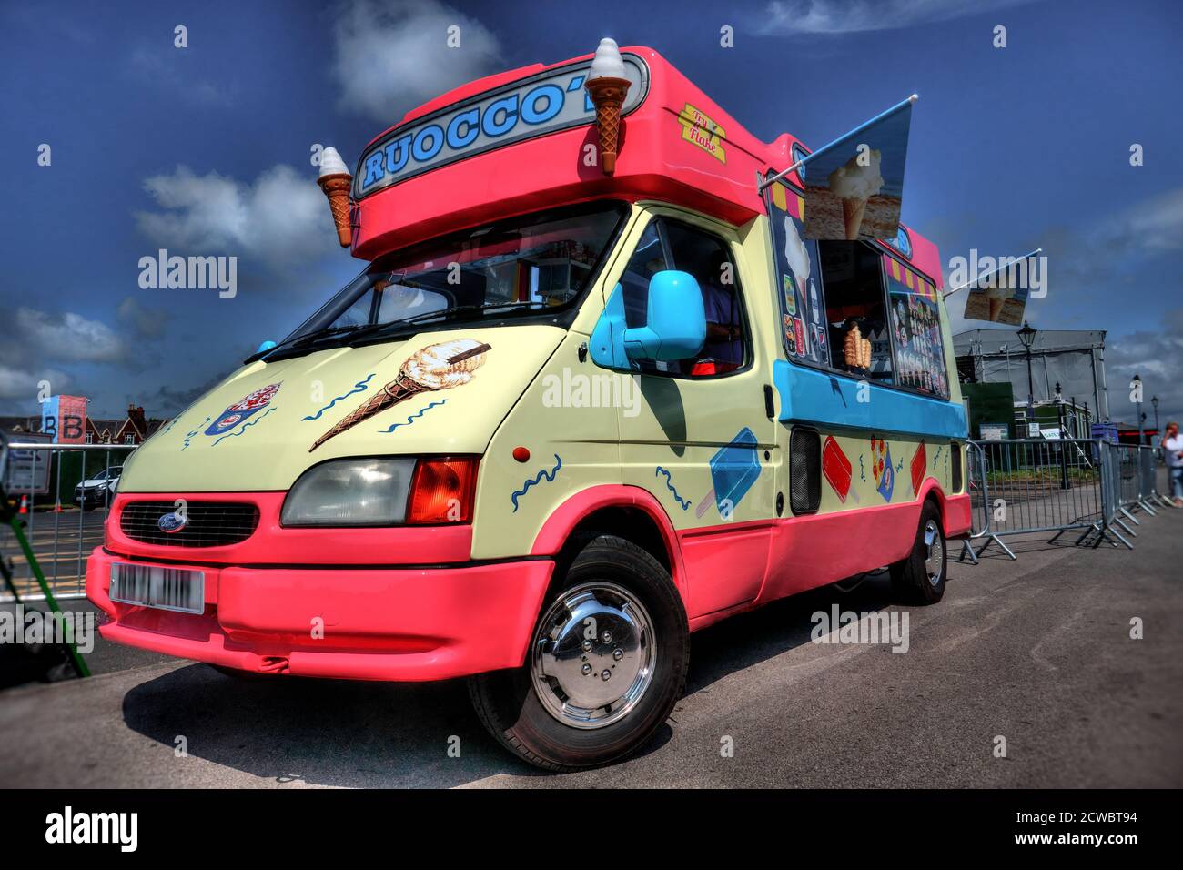 Traditional British UK icecream van in pink and white barked near