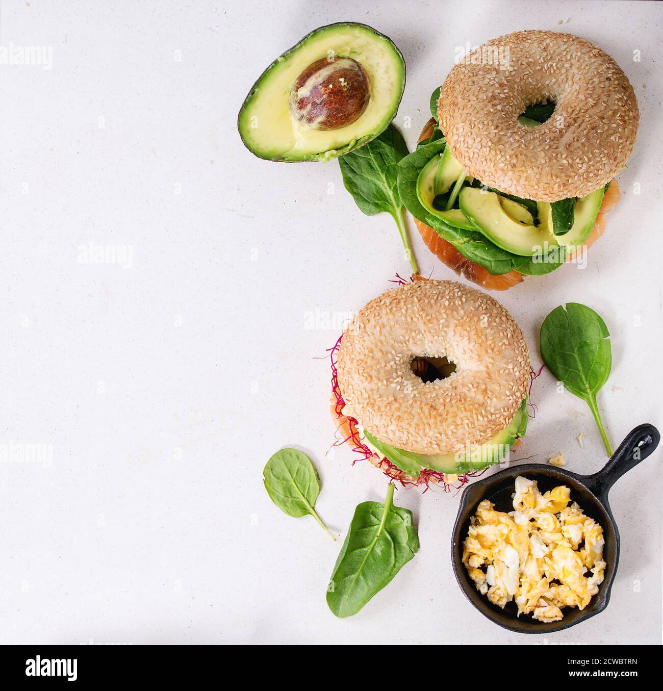 Two Bagels with salted salmon, spinach, beet sprouts, avocado and