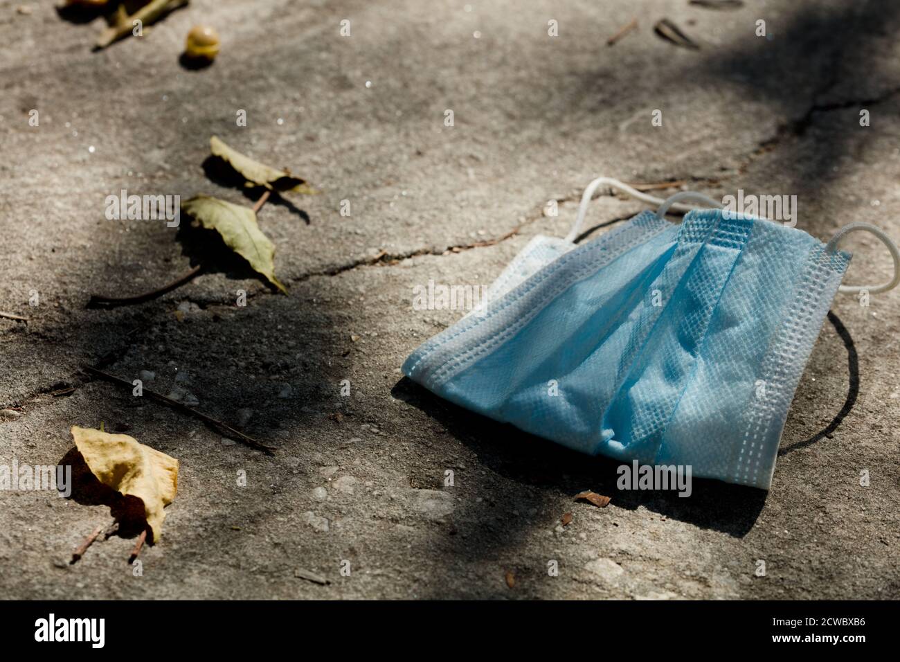 Medical protection mask lost on the ground was used. Disposable mask ...