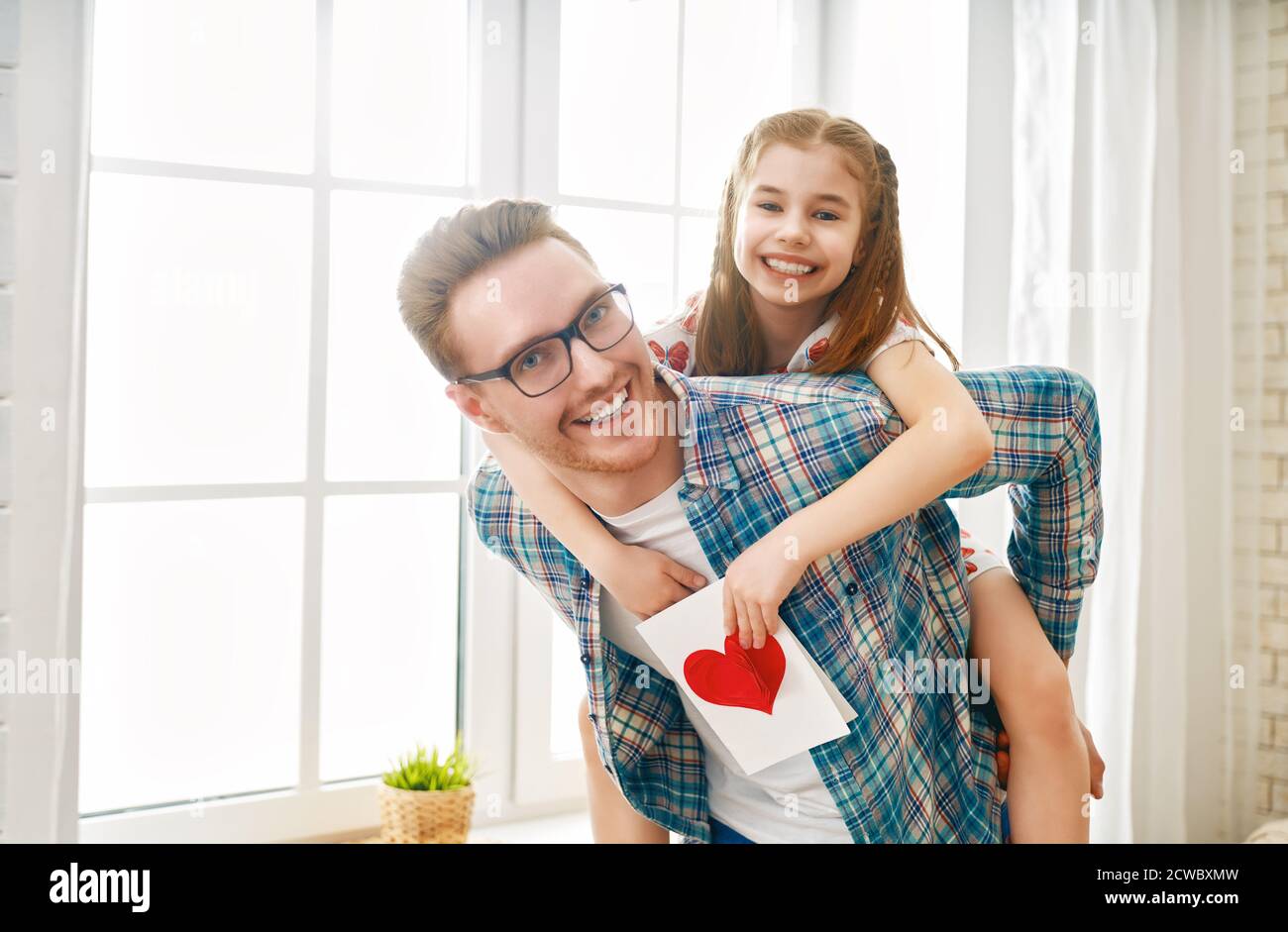 Happy father's day! Child daughter congratulating dad and giving him ...