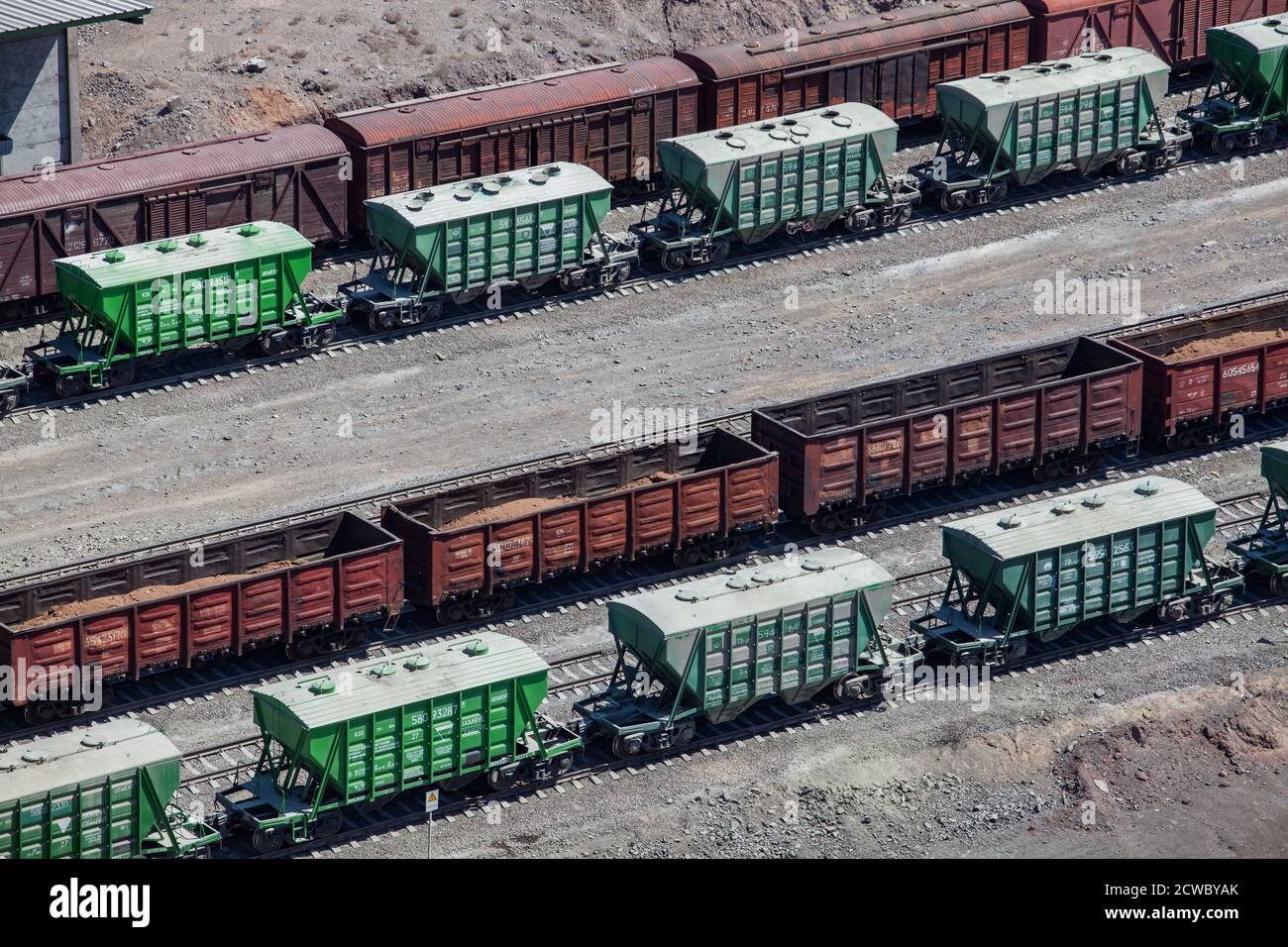 Mynaral/Kazakhstan - April 23 2012: Railroad terminal. Rail carriages hopper car on tracks. Modern cement plant in desert. Balkhash lake, Kazakhstan. Stock Photo