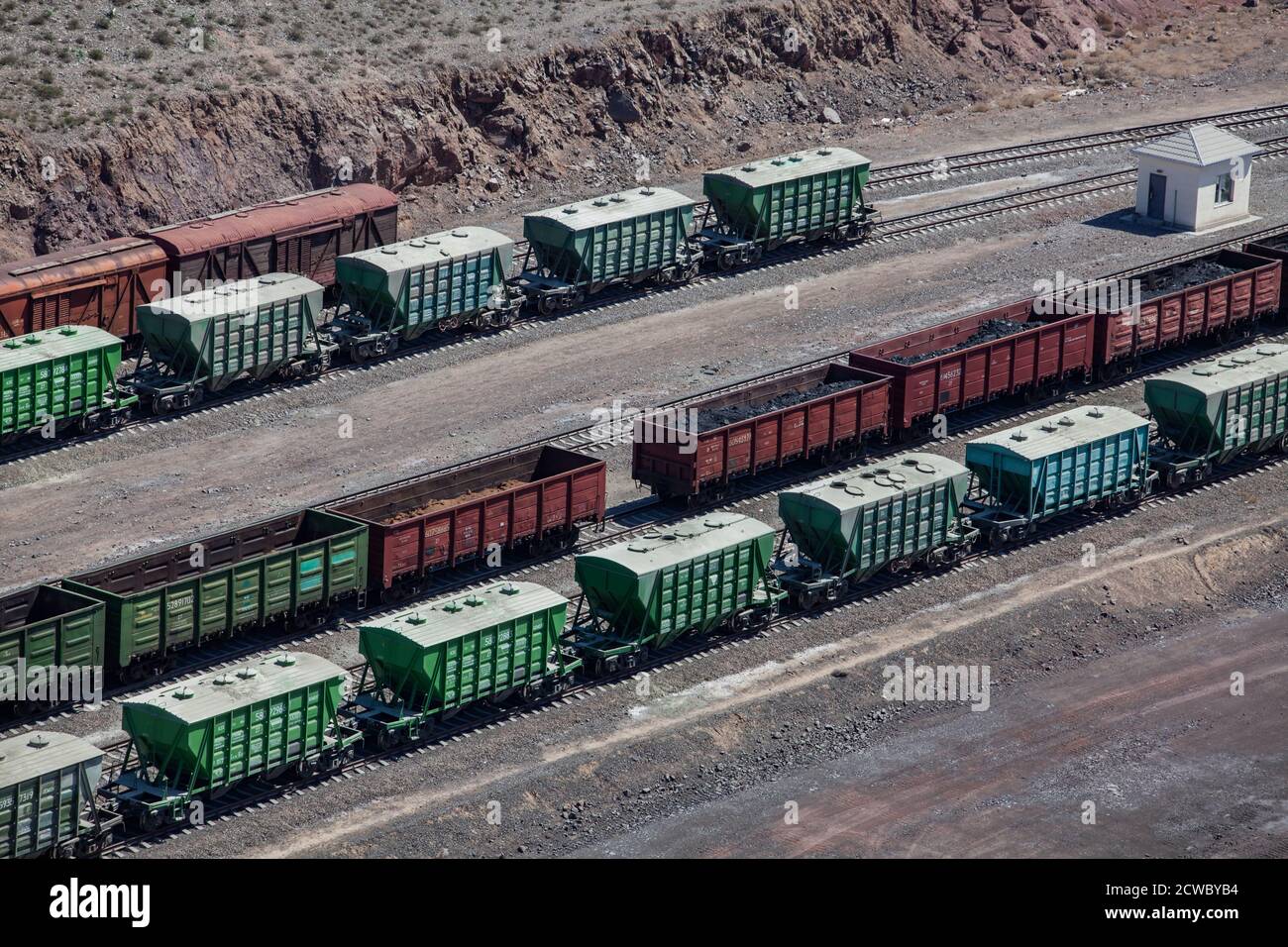 Mynaral/Kazakhstan - April 23 2012: Jambyl Cement plant. Hopper car train at loading terminal (station). Aerial view. Stock Photo