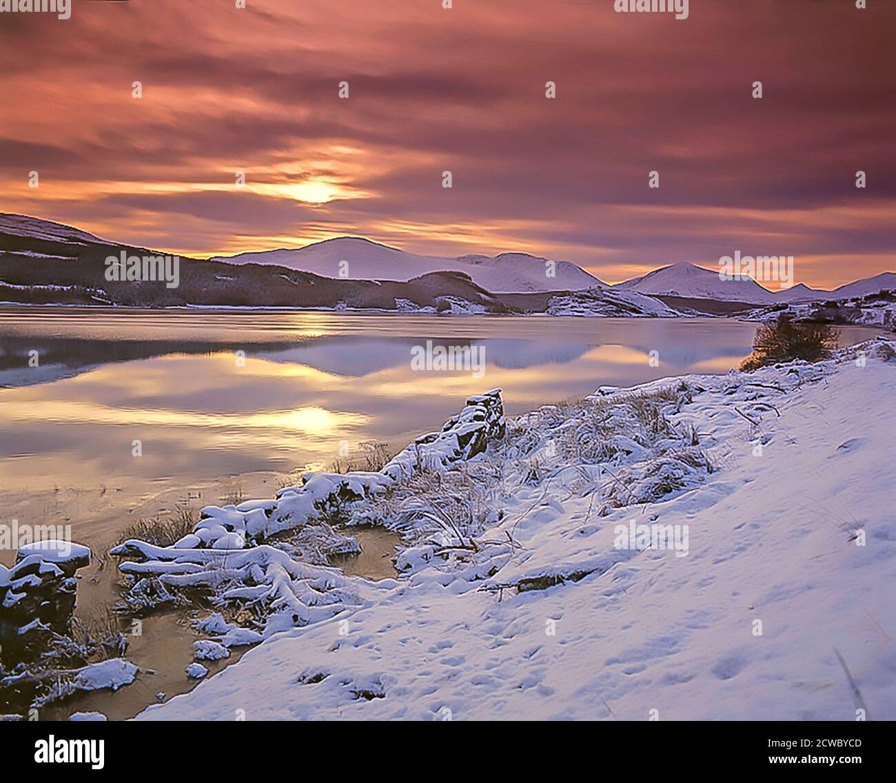 A Winters sunset over the Lochaber Hills from Moy Loch on Creag Meagaidh, Glen Spean. Stock Photo