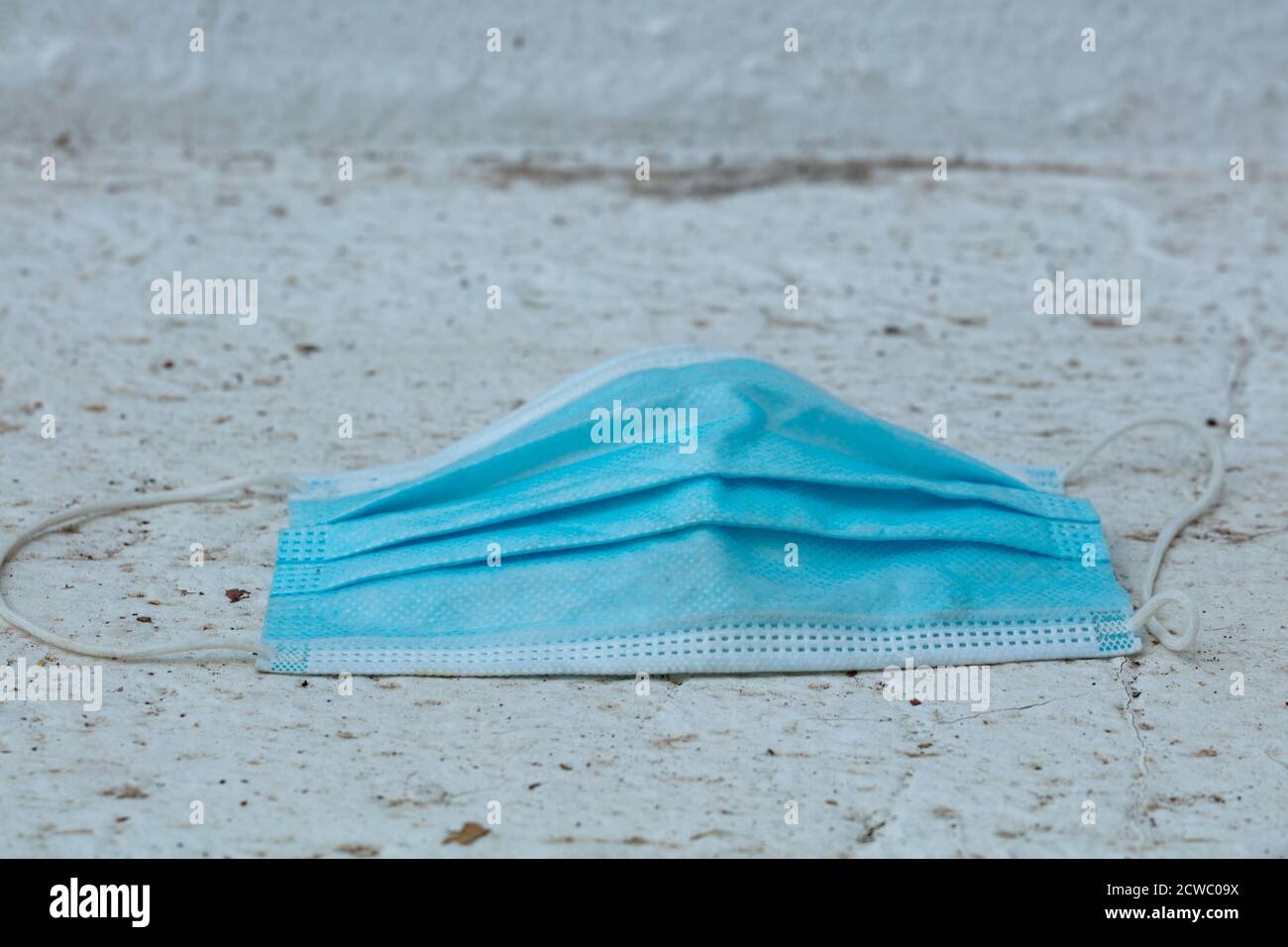 Medical protection mask lost on the ground was used. Disposable mask ...