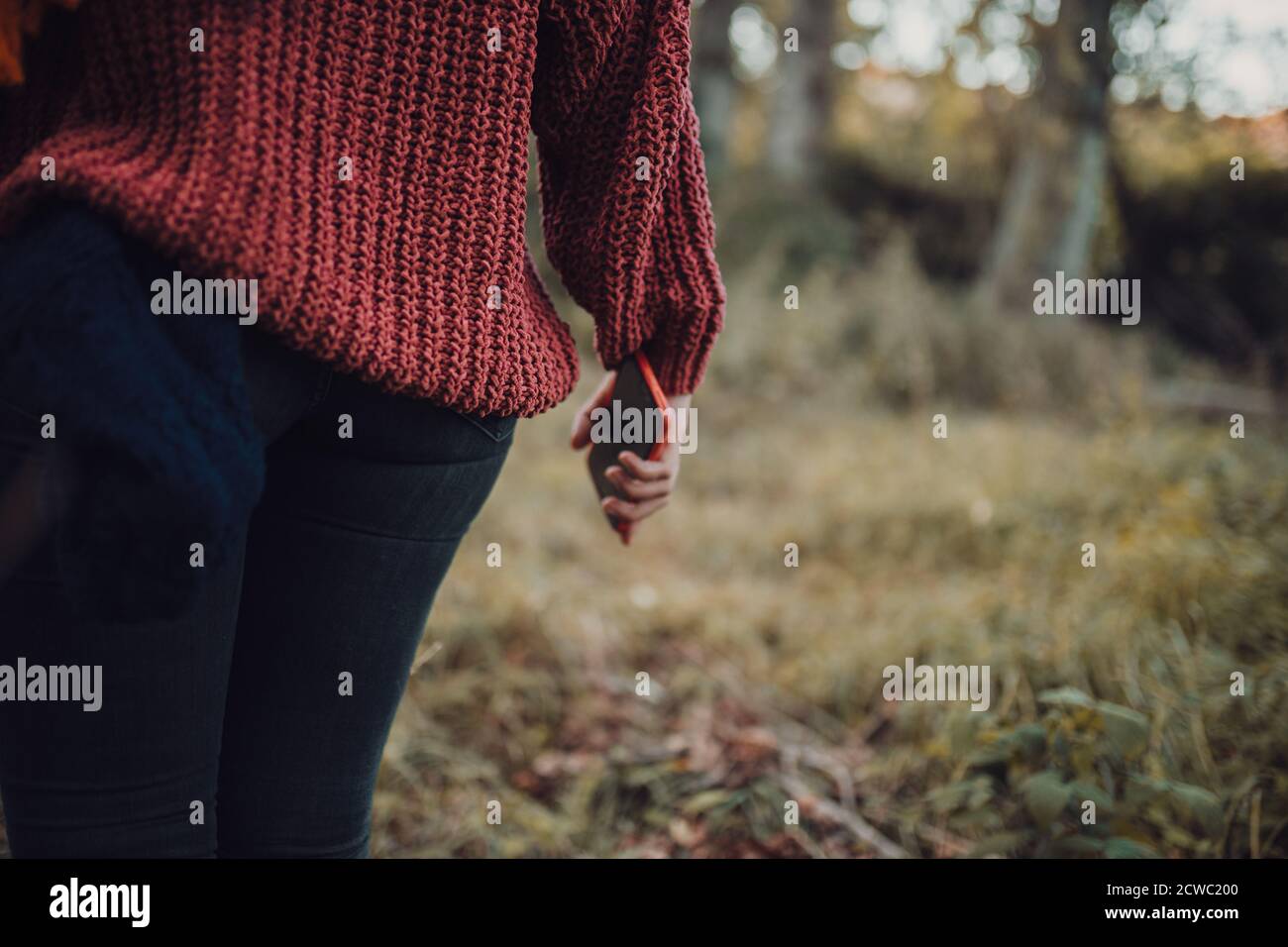 Woman trekking through forest hi-res stock photography and images - Alamy