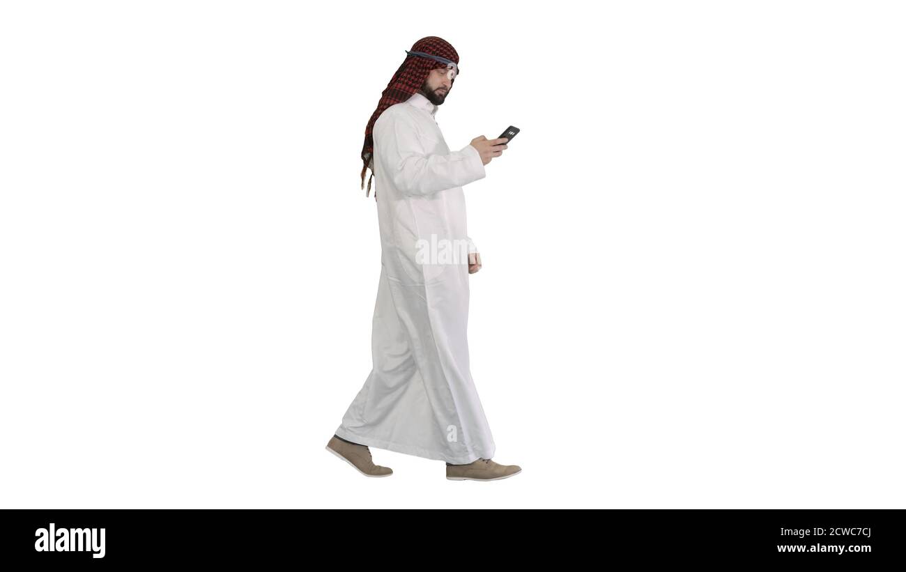 Arab man using his smartphone surfing on the internet or messagi Stock Photo