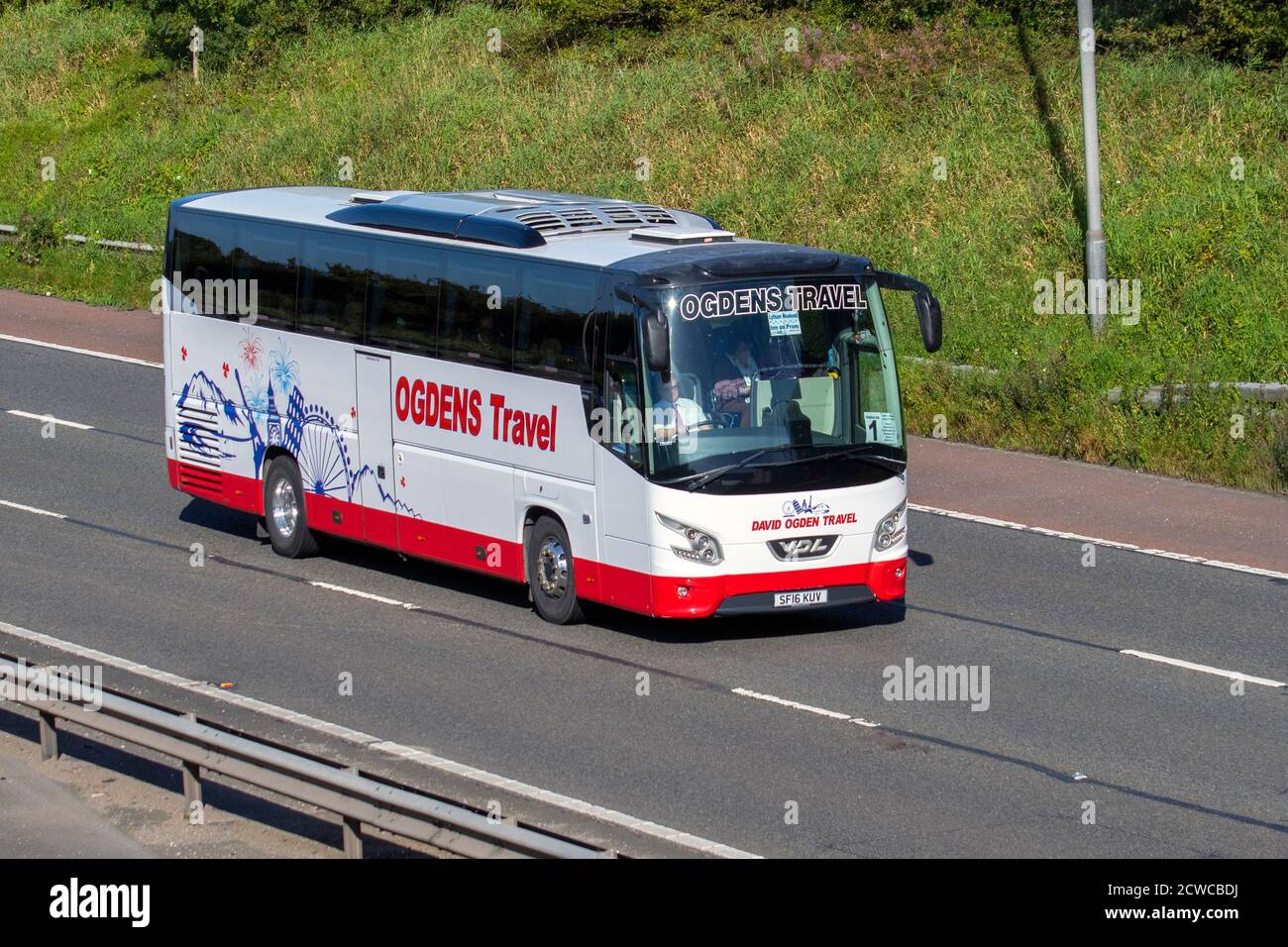 Ogdens Travel Coach passenger traffic, moving 2016 Vdl Futura Fhd2-122 PSV vehicles, buses driving vehicle on UK roads, luxury motors, holiday excursion, holidays & travel motoring on the M6 motorway highway network, UK Stock Photo