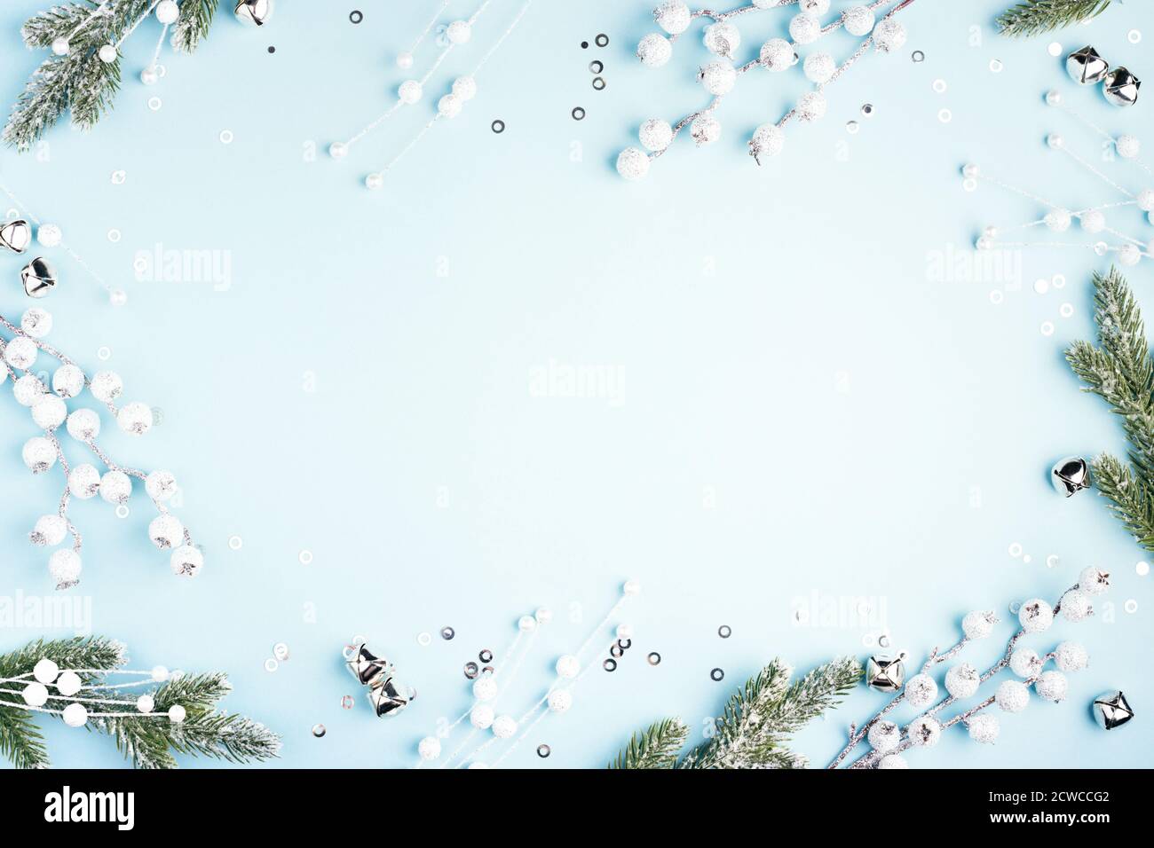 Christmas frame with fir branches and decorations on blue background ...