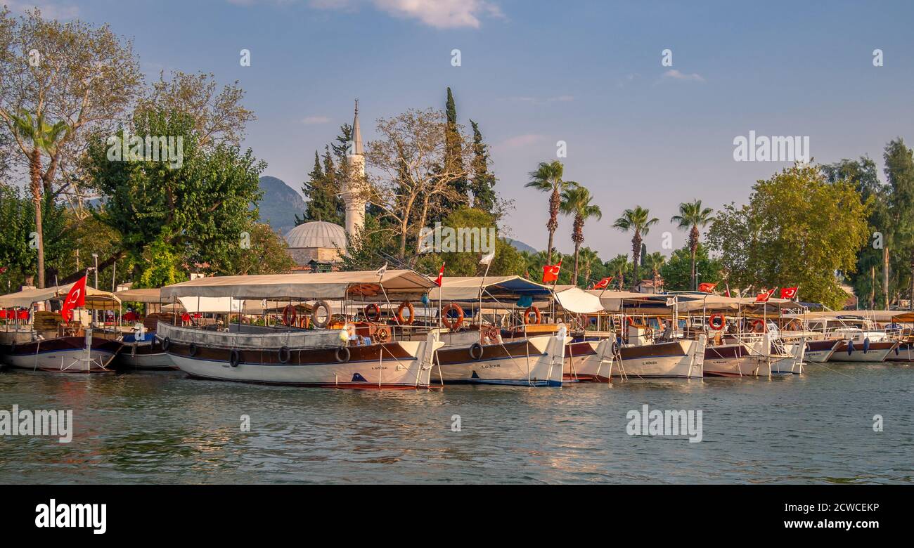 Taxi boats waiting in front of the town mosque to take tourists to Iztuzu Beach, Dalyan, Mugla, Turkey Stock Photo