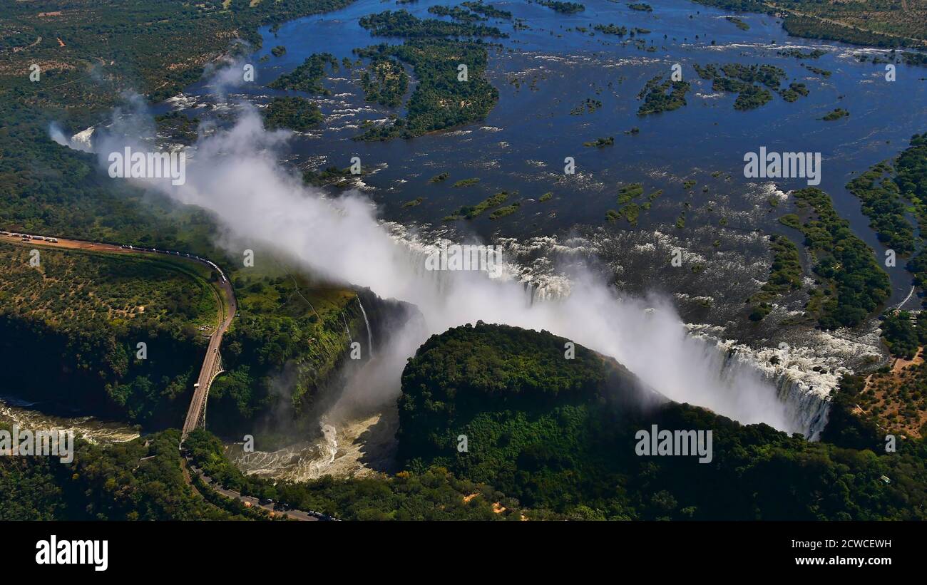 Stunning aerial panorama view of the majestic and powerful Victoria Falls (largest waterfall worldwide) in full length at the end of rainy season. Stock Photo
