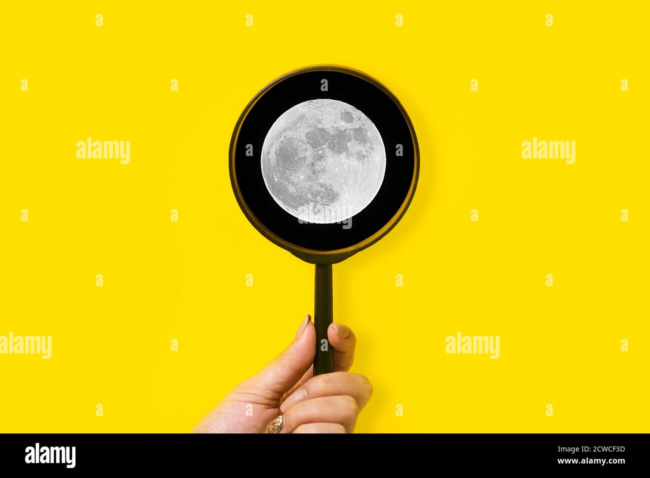 moon under a magnifying glass, space exploration concept Stock Photo