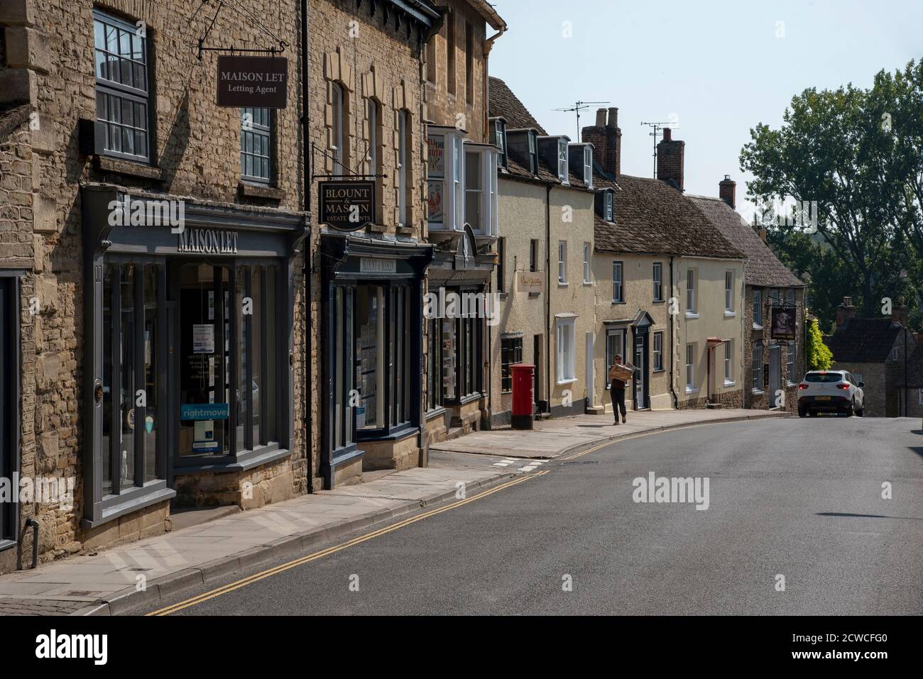 Malmesbury, Wiltshire, England, UK. 2020.  Old shops and housing on the High Street in Malmesbury, Wiltshire on the High Street  in this market town, Stock Photo
