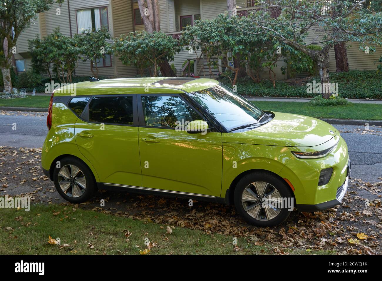 A  lime green Kia Soul compact crossover SUV parked on a residential street Stock Photo