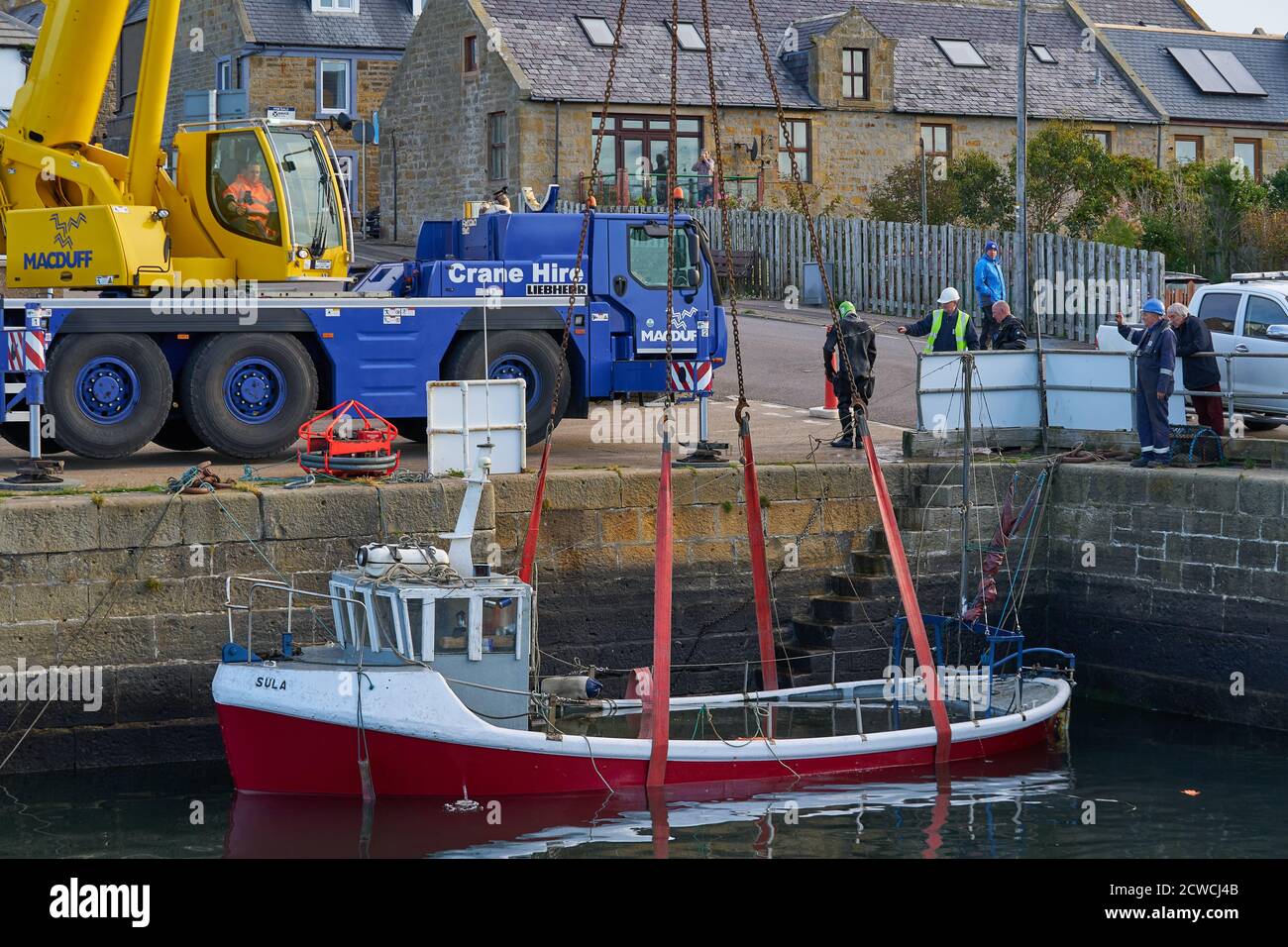 Burghead Harbour, Moray, UK. 29th Sep, 2020. UK. This is the small fishing boat Sula which sank due to a faulty valve system within the Harbour 27/28 Sep. This shows it being recovered from the depths by using a Crane and Divers. Credit: JASPERIMAGE/Alamy Live News Stock Photo
