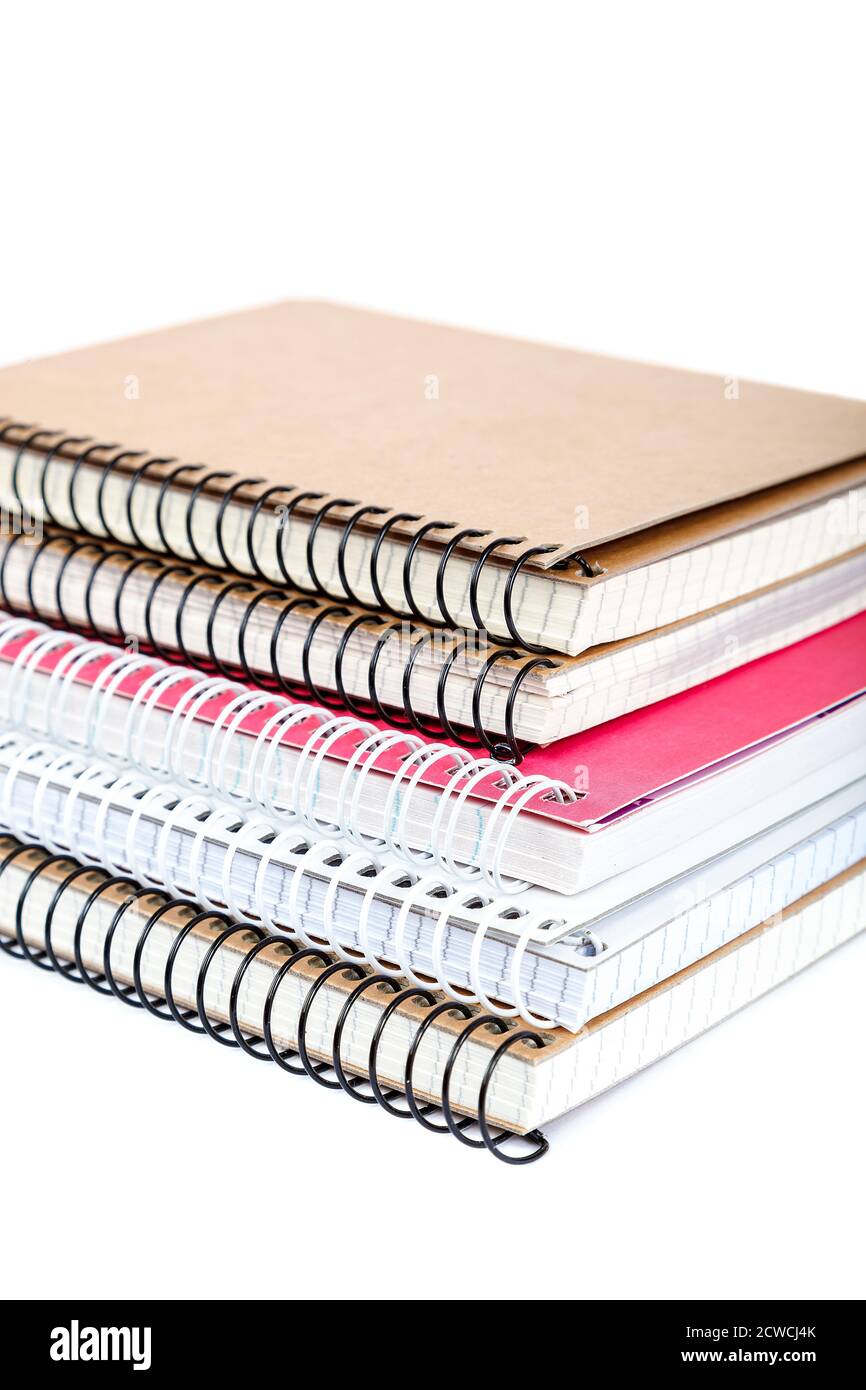 Stack spring notebooks isolated on white background Stock Photo - Alamy