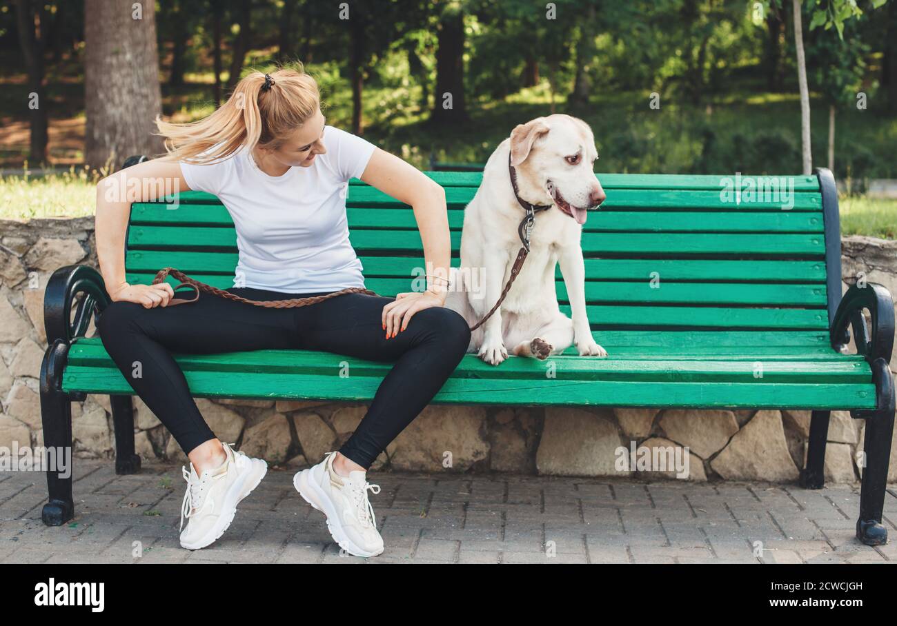 Lady sitting on bench with dog hi-res stock photography and images - Alamy