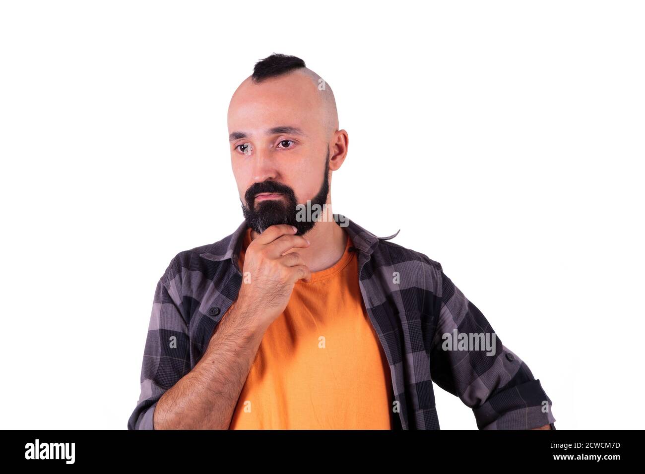Young hispanic man immerse in deep thinking Stock Photo