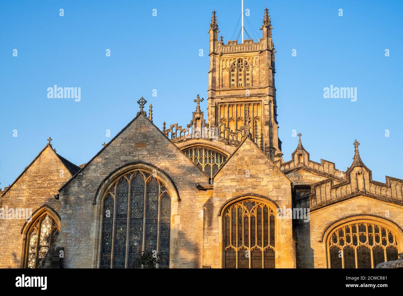 The Church of St. John the Baptist from the garden of rememberance at sunrise in autumn. Cirencester, Cotswolds, Gloucestershire, England Stock Photo