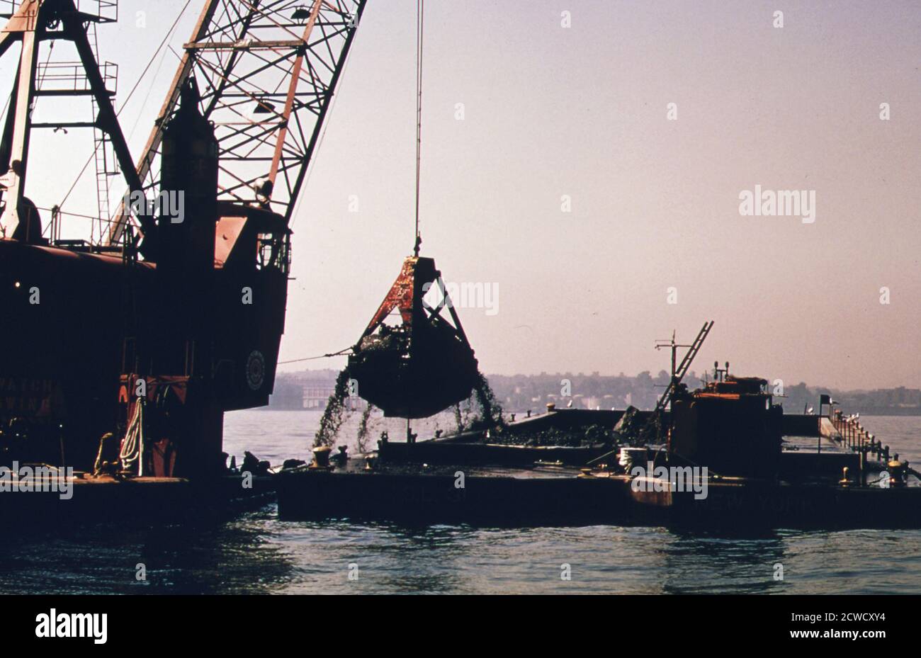 The U.S. Army Corps of Engineers dredging in the New York Harbor for spoils that will be dumped in the New York bight ca.  July 1974 Stock Photo